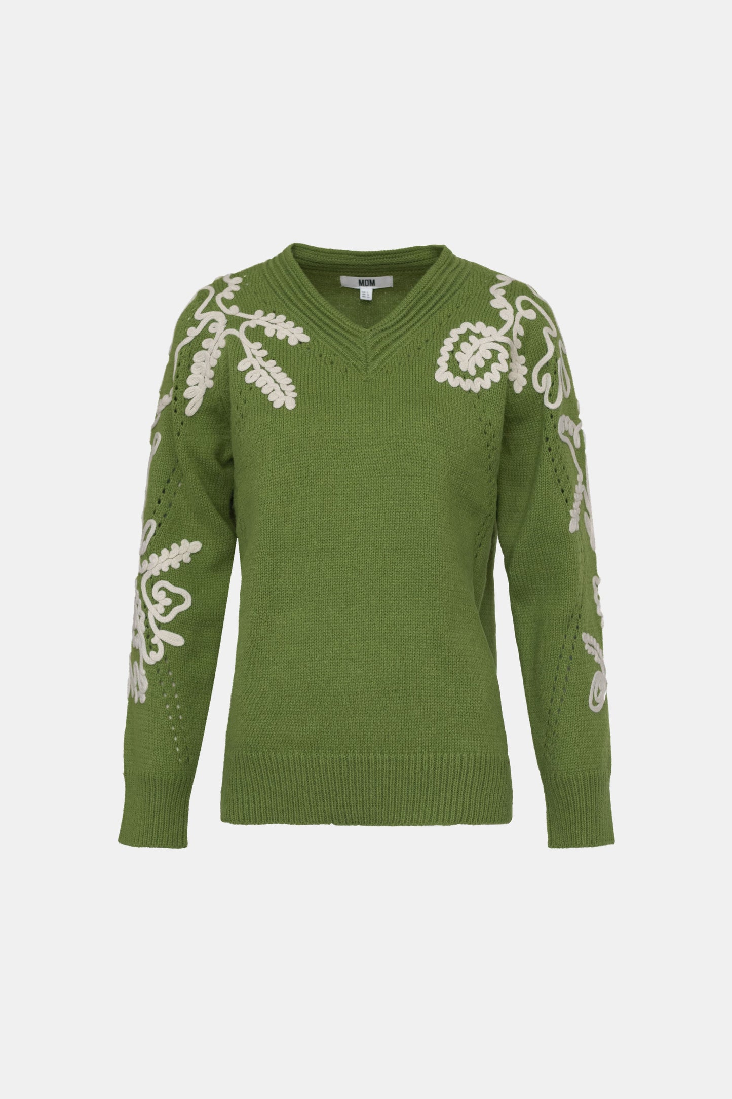 Green sweater with white floral patterns on a white background