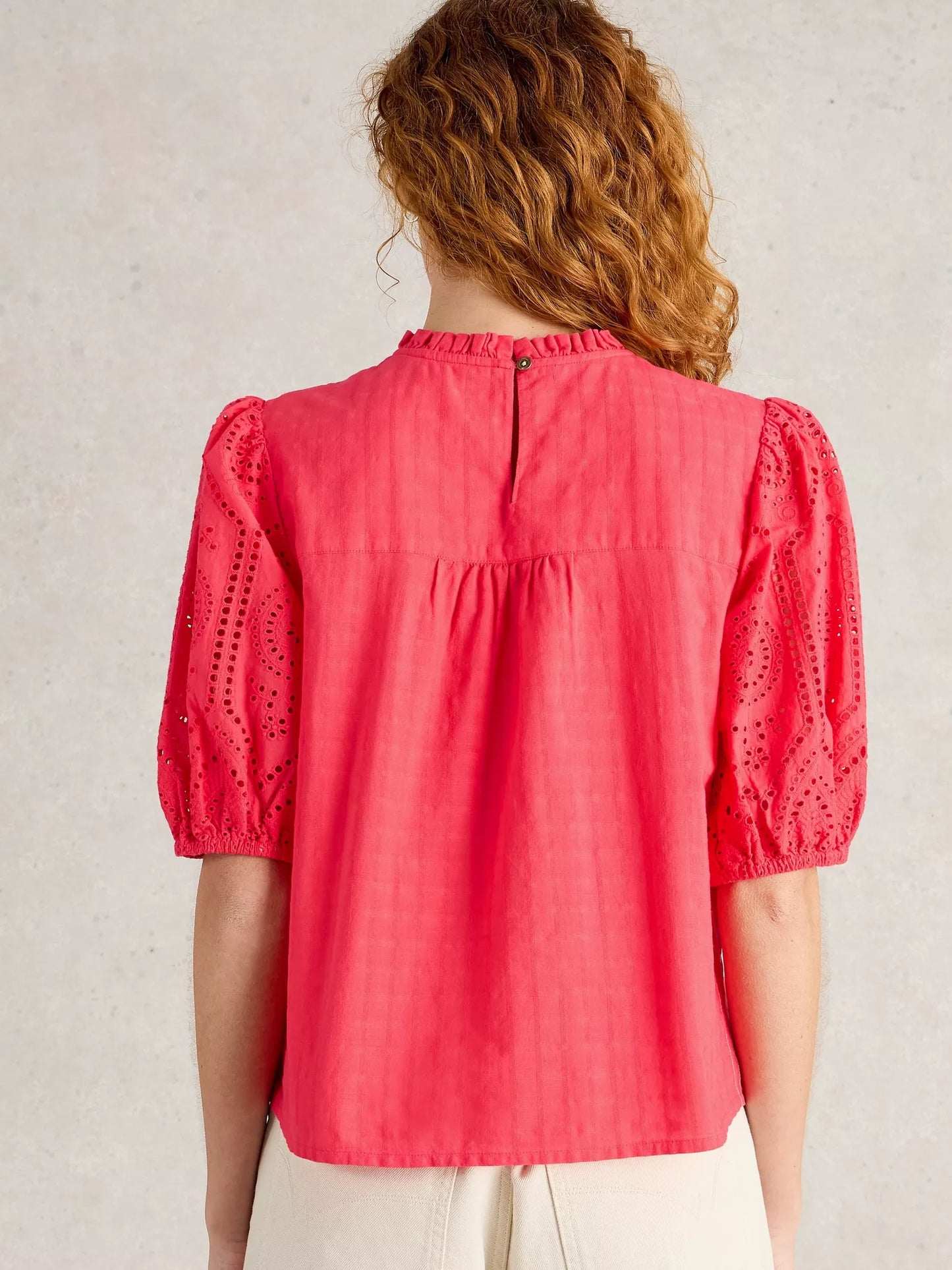 the Lexi Cotton Broderie Top! Featuring delicate broderie lace detailing and a bright coral pink colou
