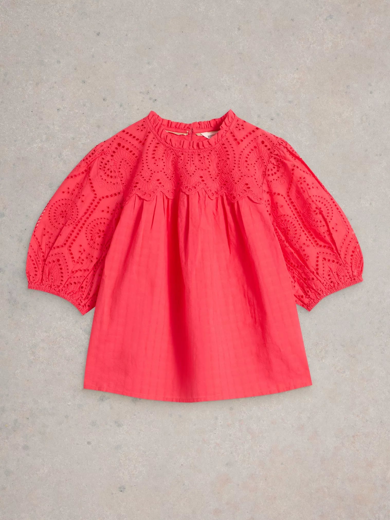 the Lexi Cotton Broderie Top! Featuring delicate broderie lace detailing and a bright coral pink colou