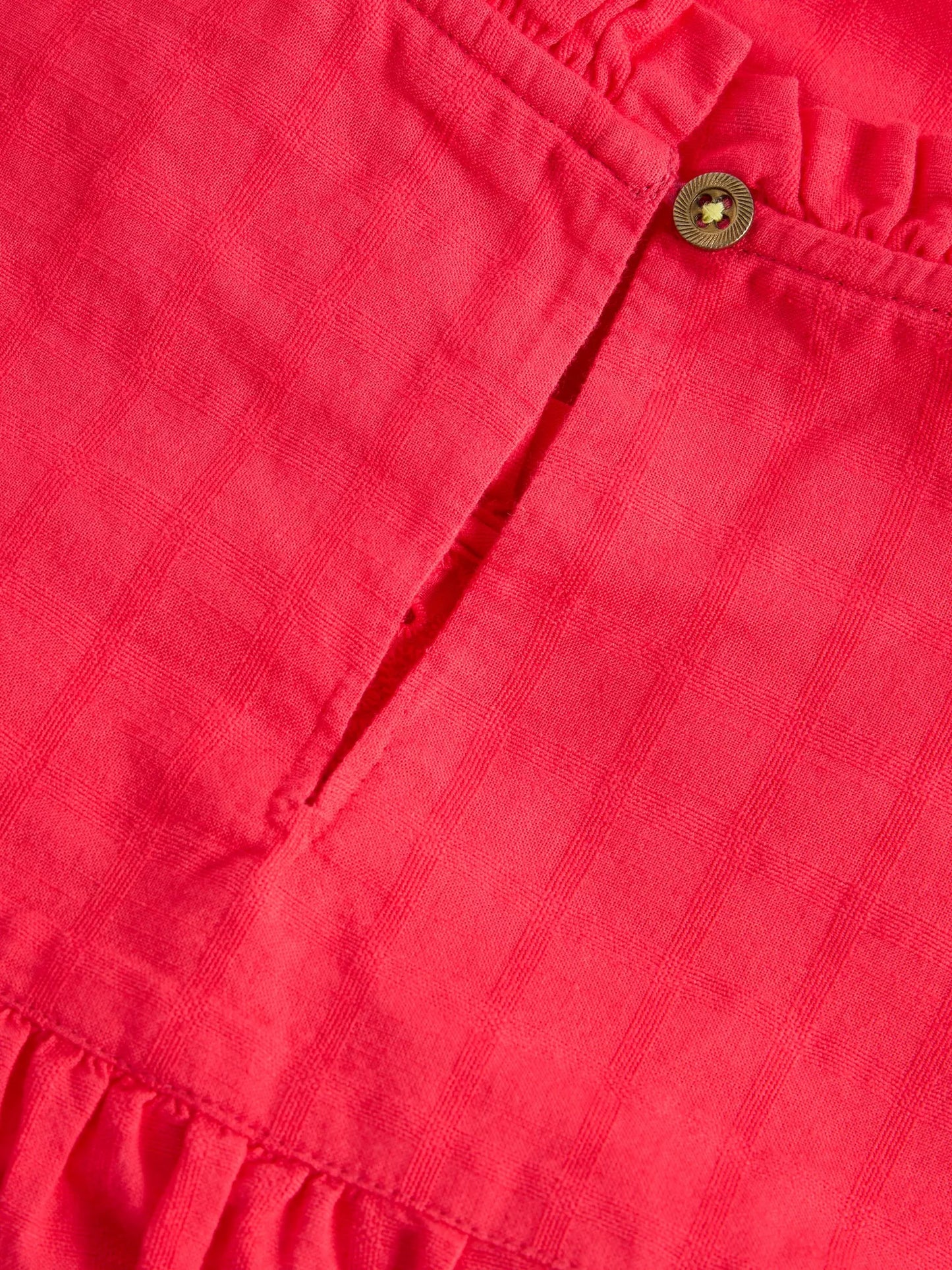 the Lexi Cotton Broderie Top! Featuring delicate broderie lace detailing and a bright coral pink colou