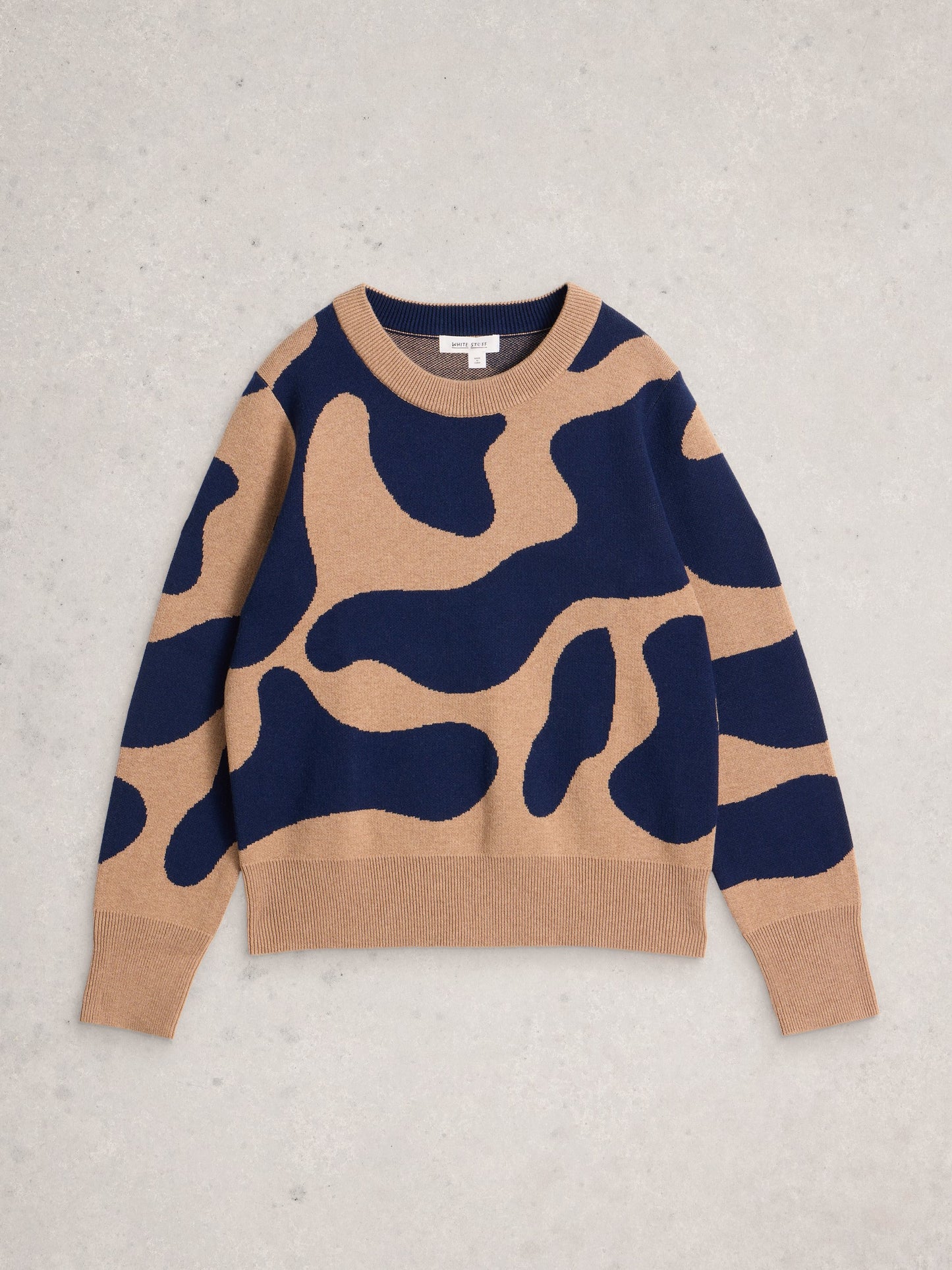 Camouflage-patterned sweater on a light gray background