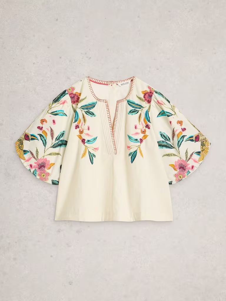Floral embroidered blouse on a light gray background