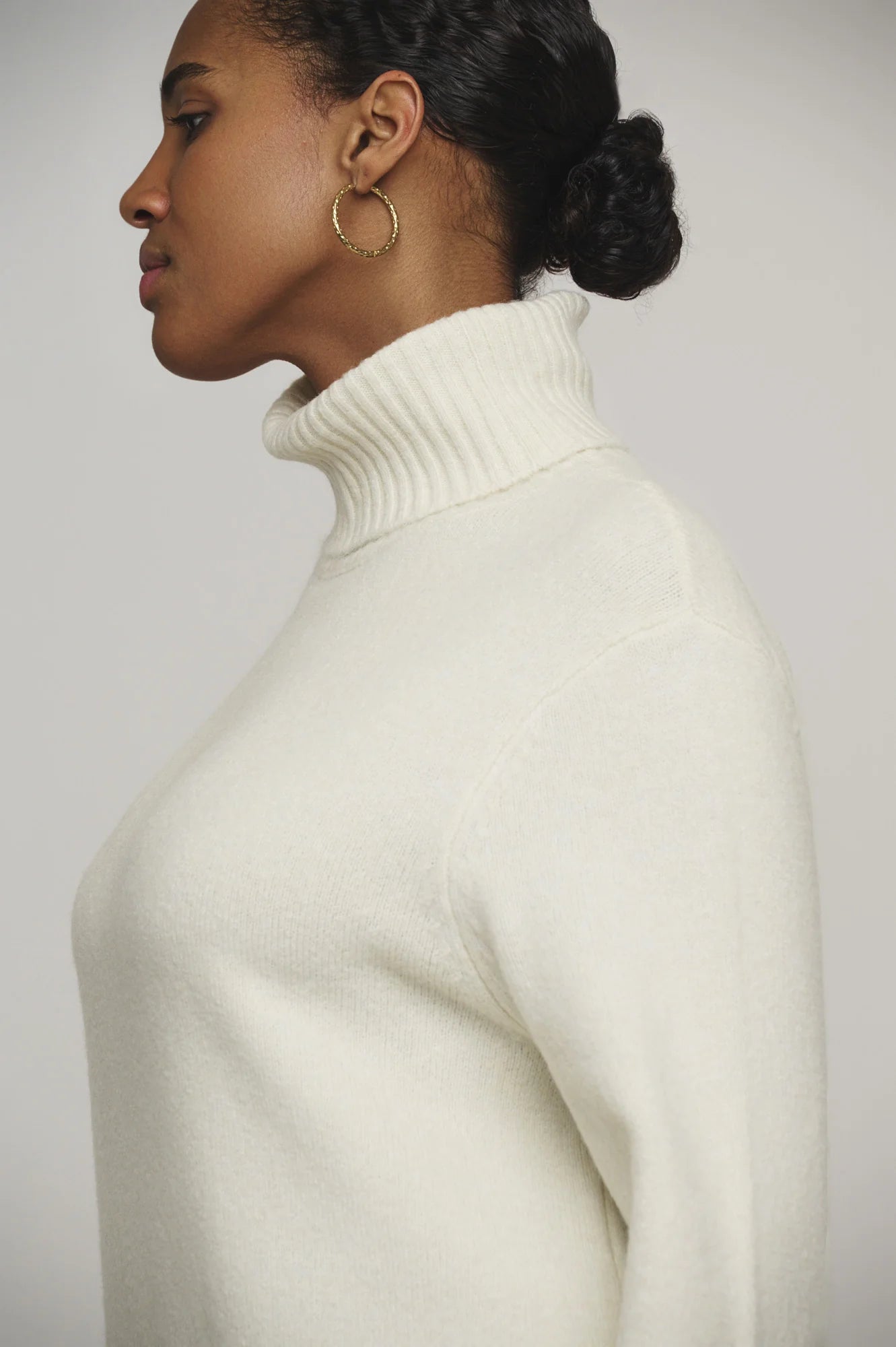 Snuggle up in this knit ivory Tenzil dress from Rino & Pelle for a playful turtleneck, ribbed details, cool side slits, and ultimate comfort. Add some knee high boots and you're ready to hit the town!