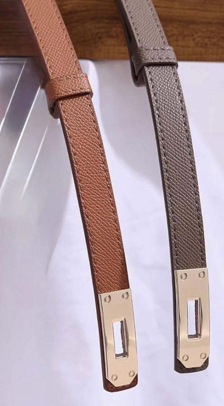 Two belts with gold buckles on a white background