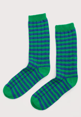 Green and blue striped socks on a light gray background