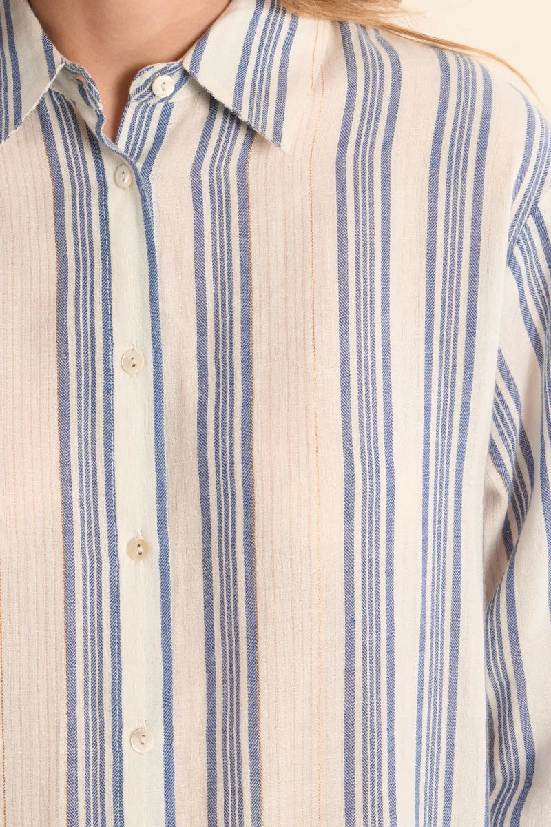Close-up of a person wearing a blue and white striped shirt.