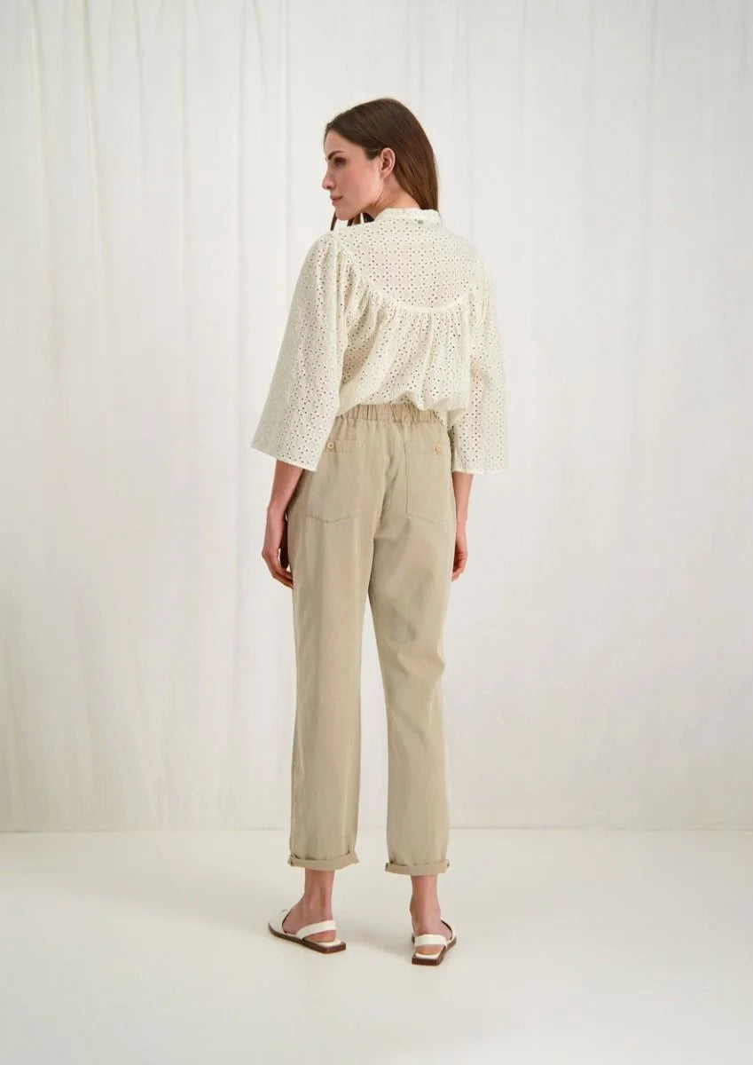 Introducing the Merlin Blouse by Circle of Trust in Antique White. Made from soft 100% cotton eyelet fabric, it's comfy and breathable. With its loose fit and wide 3/4 sleeves, it's effortlessly stylish. Featuring delicate embroidery, a classic crew neck, and a button placket, it's a versatile piece for any occasion. Dress it up or down, it's bound to be one of the prettiest blouses in your wardrobe.