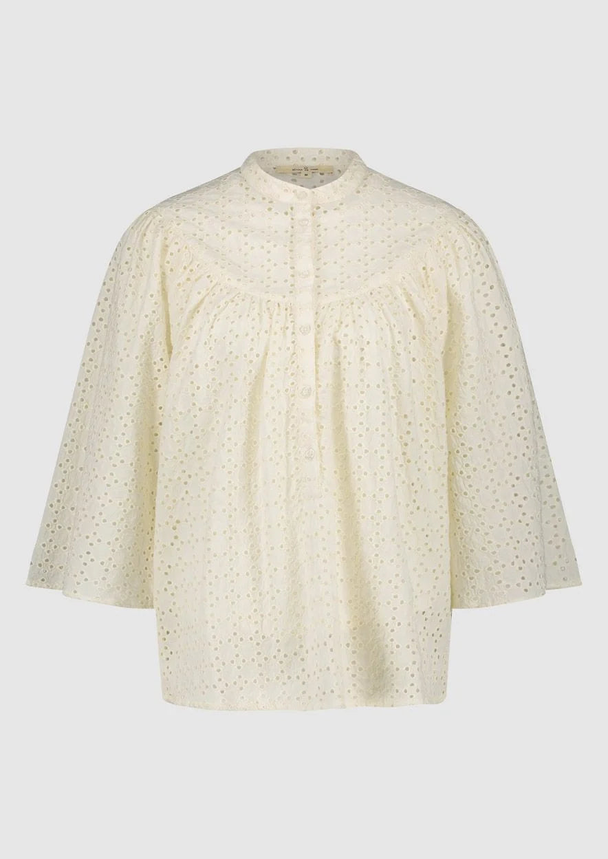 Introducing the Merlin Blouse by Circle of Trust in Antique White. Made from soft 100% cotton eyelet fabric, it's comfy and breathable. With its loose fit and wide 3/4 sleeves, it's effortlessly stylish. Featuring delicate embroidery, a classic crew neck, and a button placket, it's a versatile piece for any occasion. Dress it up or down, it's bound to be one of the prettiest blouses in your wardrobe.
