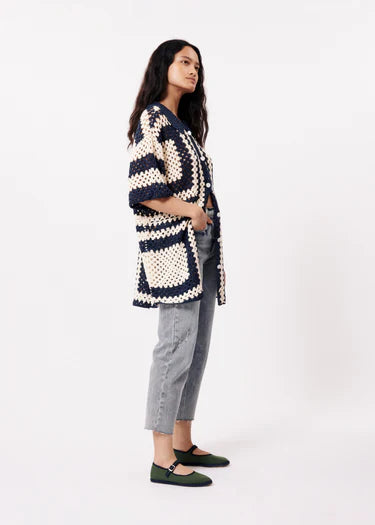 This Pilar Crochet Cardiganin cream and navy from FRNCH is perfect for creating a stylish summer look. Pair it with a colorful bag and comfortable flat shoes for a complete outfit. With button tabs and short, loose sleeves, this crochet shirt offers both style and freedom of movement in a straight cut design. Wear it open with a graphic tee or closed for a different look.