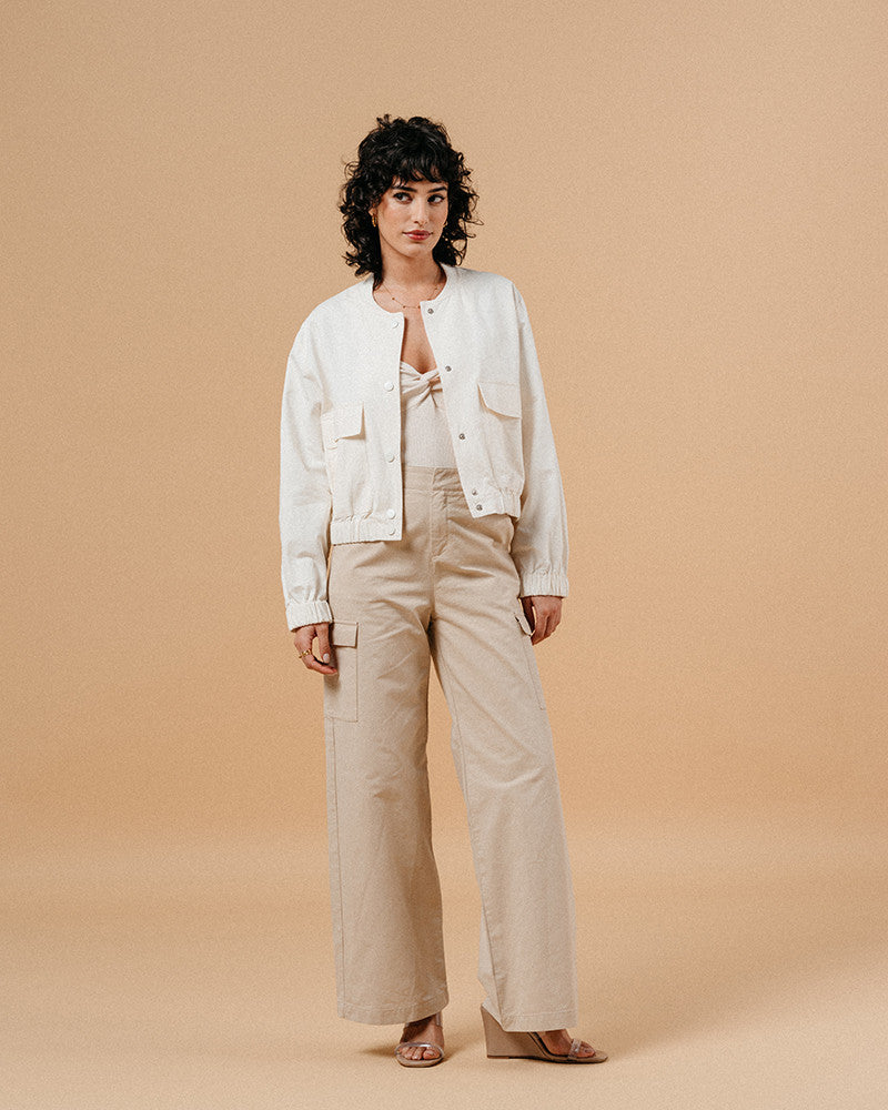 Introducing the silhouette: Bomber jackets have evolved into a cult favorite and an essential in every woman's wardrobe, especially this season. Explore our feminine and elegant take on the classic bomber: MEGANE, crafted from 100% cotton, ensuring versatility across all seasons in it's warm whate ecru colour. This cropped bomber is an absolute standout, effortlessly pairing with both pumps and sneakers alike.