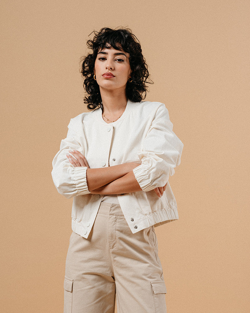 Introducing the silhouette: Bomber jackets have evolved into a cult favorite and an essential in every woman's wardrobe, especially this season. Explore our feminine and elegant take on the classic bomber: MEGANE, crafted from 100% cotton, ensuring versatility across all seasons in it's warm whate ecru colour. This cropped bomber is an absolute standout, effortlessly pairing with both pumps and sneakers alike.