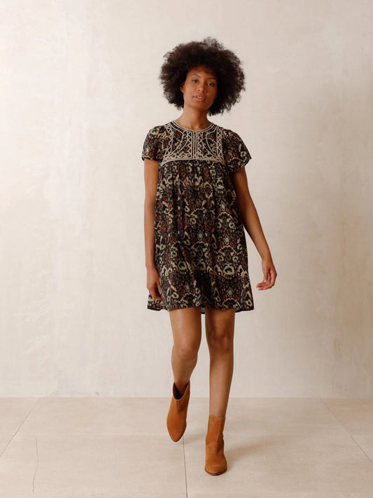 The Chevron Embroidered dress by Indi & Cold has chevron-detail embroidery, ethnic print and lightweight fabric with a very nice drape. It features a round neck that closes with a button, a fitted shoulder and short sleeves. The perfect balance of unique and classic.