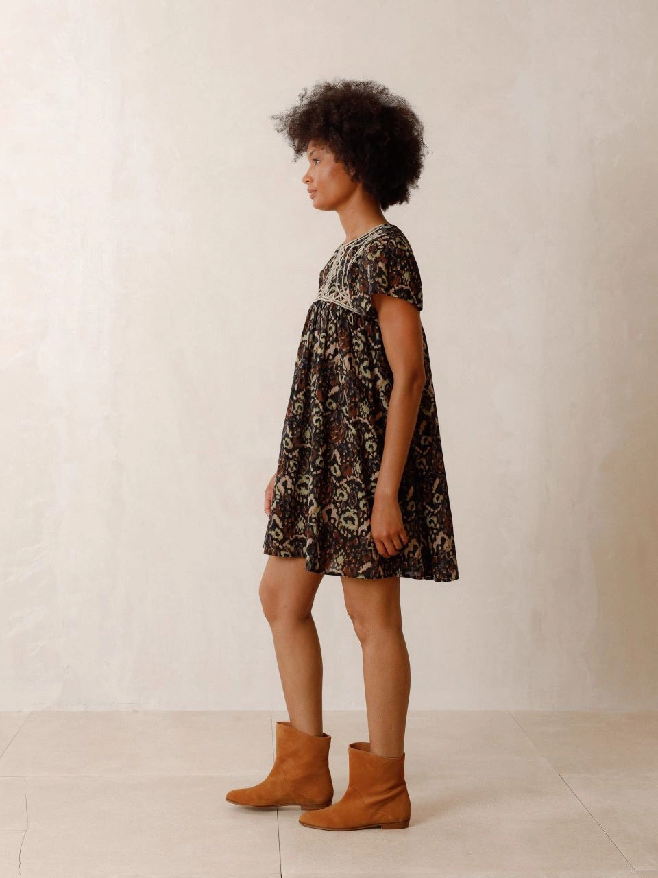 The Chevron Embroidered dress by Indi & Cold has chevron-detail embroidery, ethnic print and lightweight fabric with a very nice drape. It features a round neck that closes with a button, a fitted shoulder and short sleeves. The perfect balance of unique and classic.