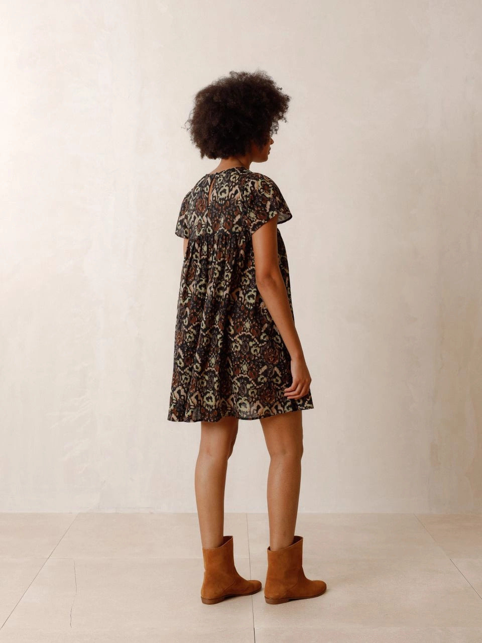 The Chevron Embroidered dress by Indi & Cold has chevron-detail embroidery, ethnic print and lightweight fabric with a very nice drape. It features a round neck that closes with a button, a fitted shoulder and short sleeves. The perfect balance of unique and classic.