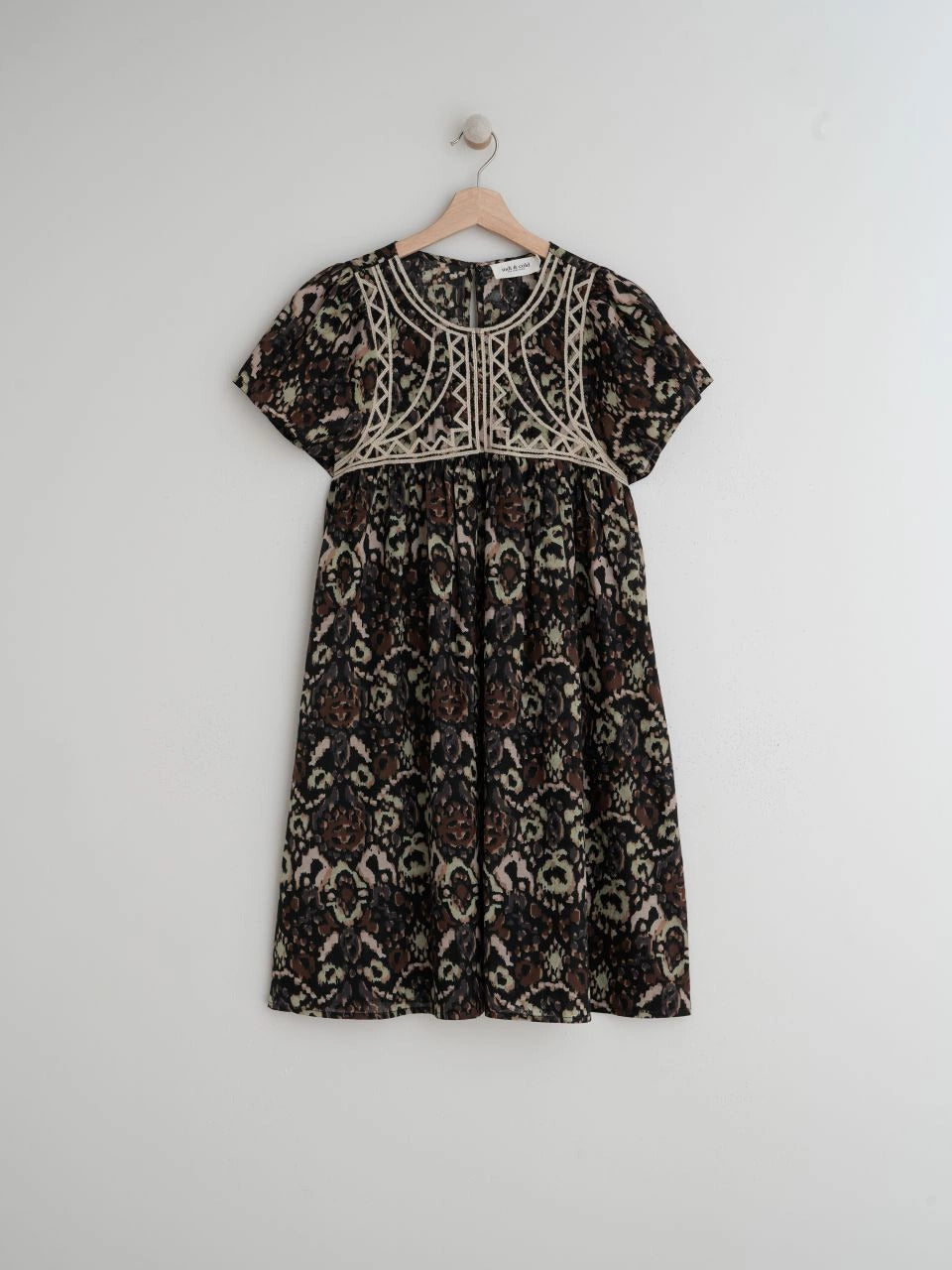 The Chevron Embroidered dress by Indi & Cold has chevron-detail embroidery, ethnic print and lightweight fabric with a very nice drape. It features a round neck that closes with a button, a fitted shoulder and short sleeves. The perfect balance of unique and classic.