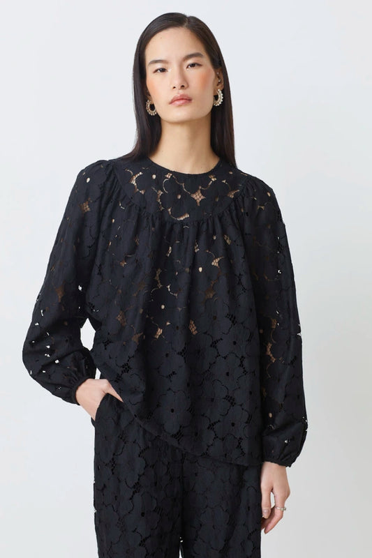 Woman wearing a black lace outfit on a white background