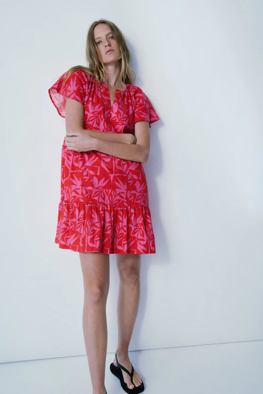 Discover the trendy and chic Robie Dress from Melissa Nepton, the perfect choice for any event. With its striking tonal jungle design in bright fuchsia and red hues, this dress adds a daring touch to your ensemble. Adorned with adorable cap sleeves, it effortlessly combines flirtatiousness with comfort. Its lightweight material allows for effortless wear, making it an ideal option for both day and night occasions. Showcase your individual style and make a statement with the Robie Dress.