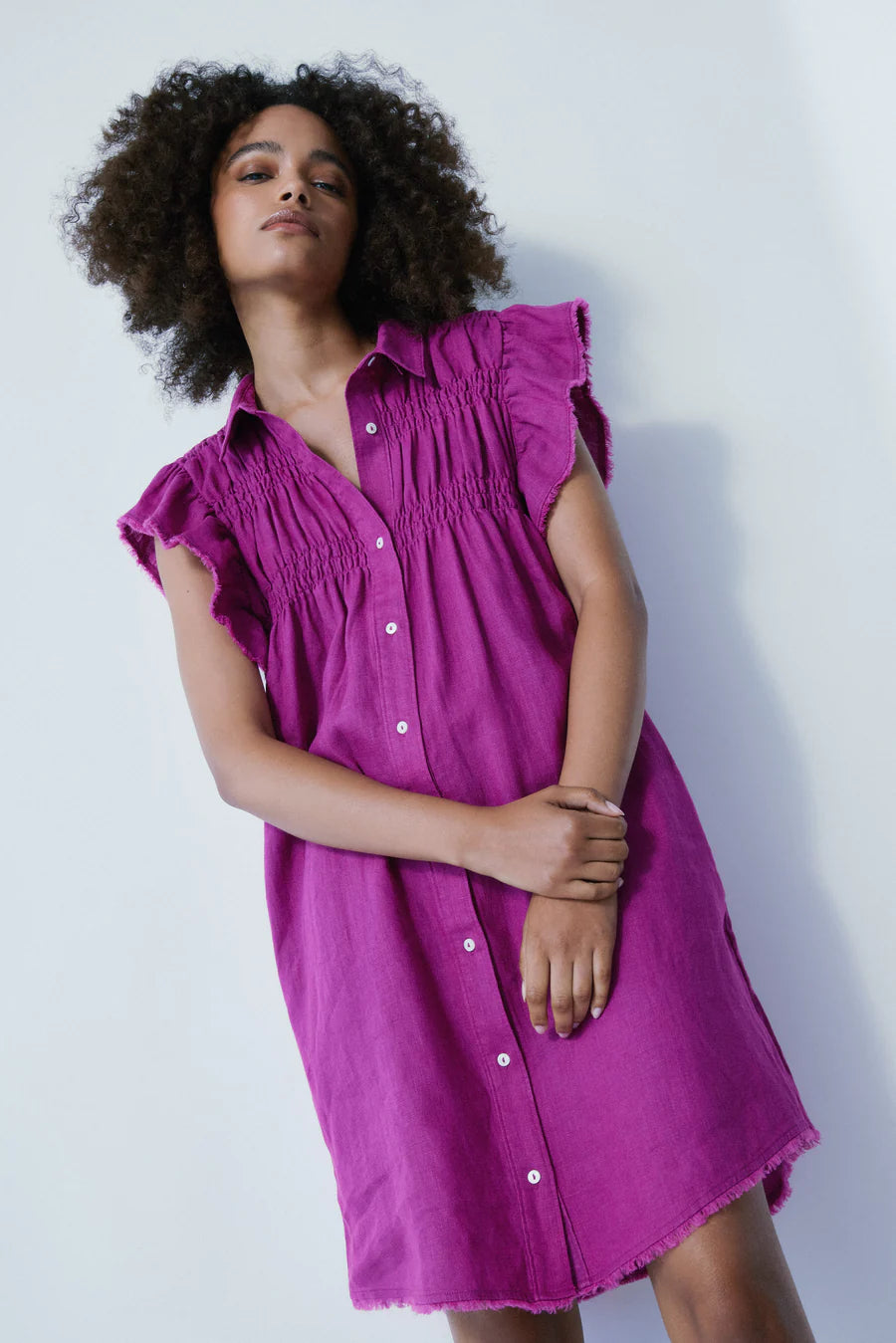 Embrace effortless elegance with the Sunset Dress by Melissa Nepton. In a captivating deep violet hue, this dress exudes sophistication for any occasion. Crafted from 100% linen, it offers breathability and comfort, perfect for warm weather days. Featuring a button-up shirt style and delicate ruffle detail on the sleeves, it adds a touch of femininity to your ensemble.