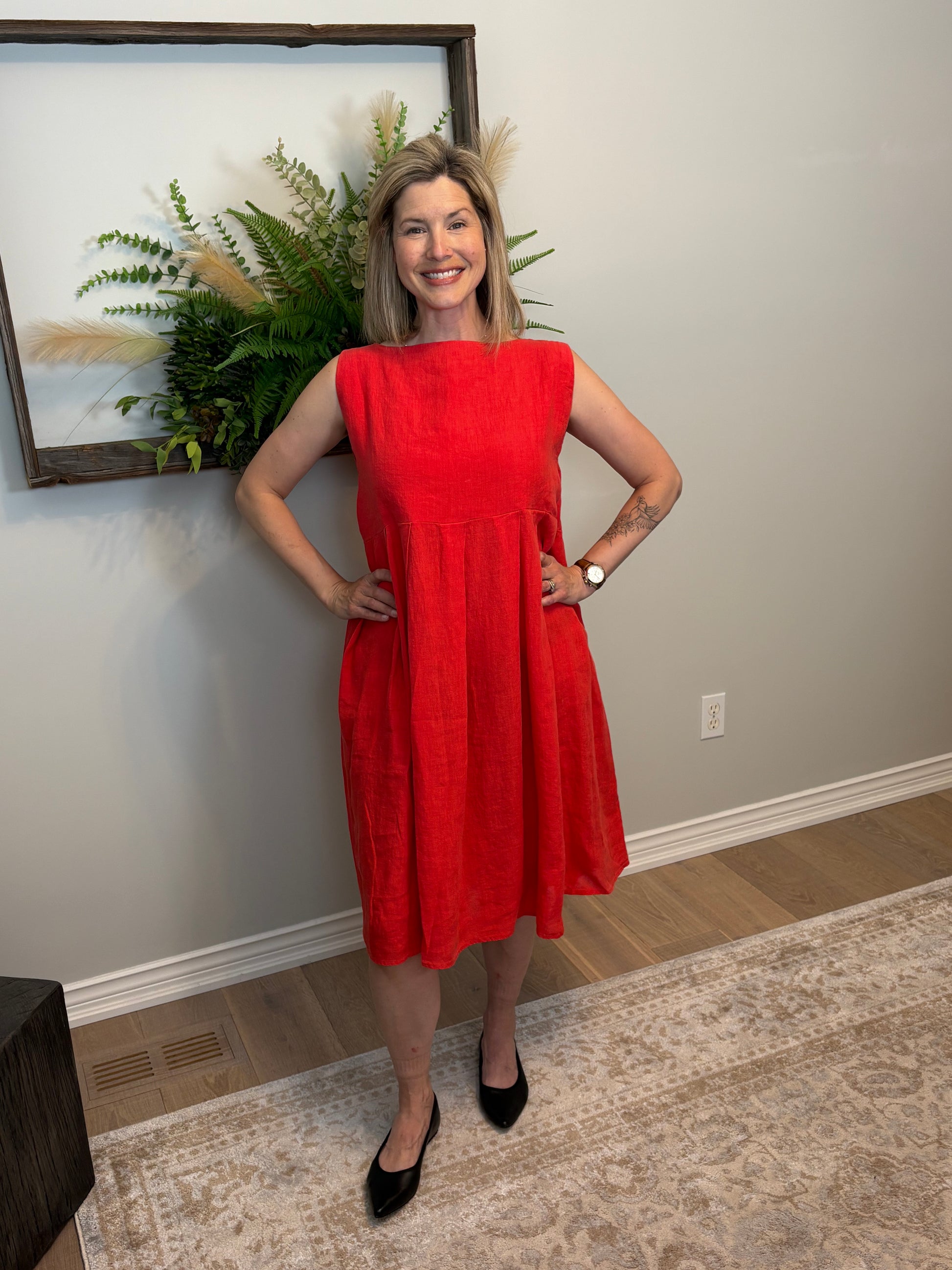 This poppy red Lully Dress by Naif is a standout piece that’s equal parts bold and breezy. Made from 100% linen, it’s lightweight and breathable—perfect for warm days. The sleeveless cut and empire waist give it a relaxed babydoll shape that feels easy and flattering, while the loose A-line fit adds to the laid-back vibe. Buttons down the back add a sweet, unexpected detail