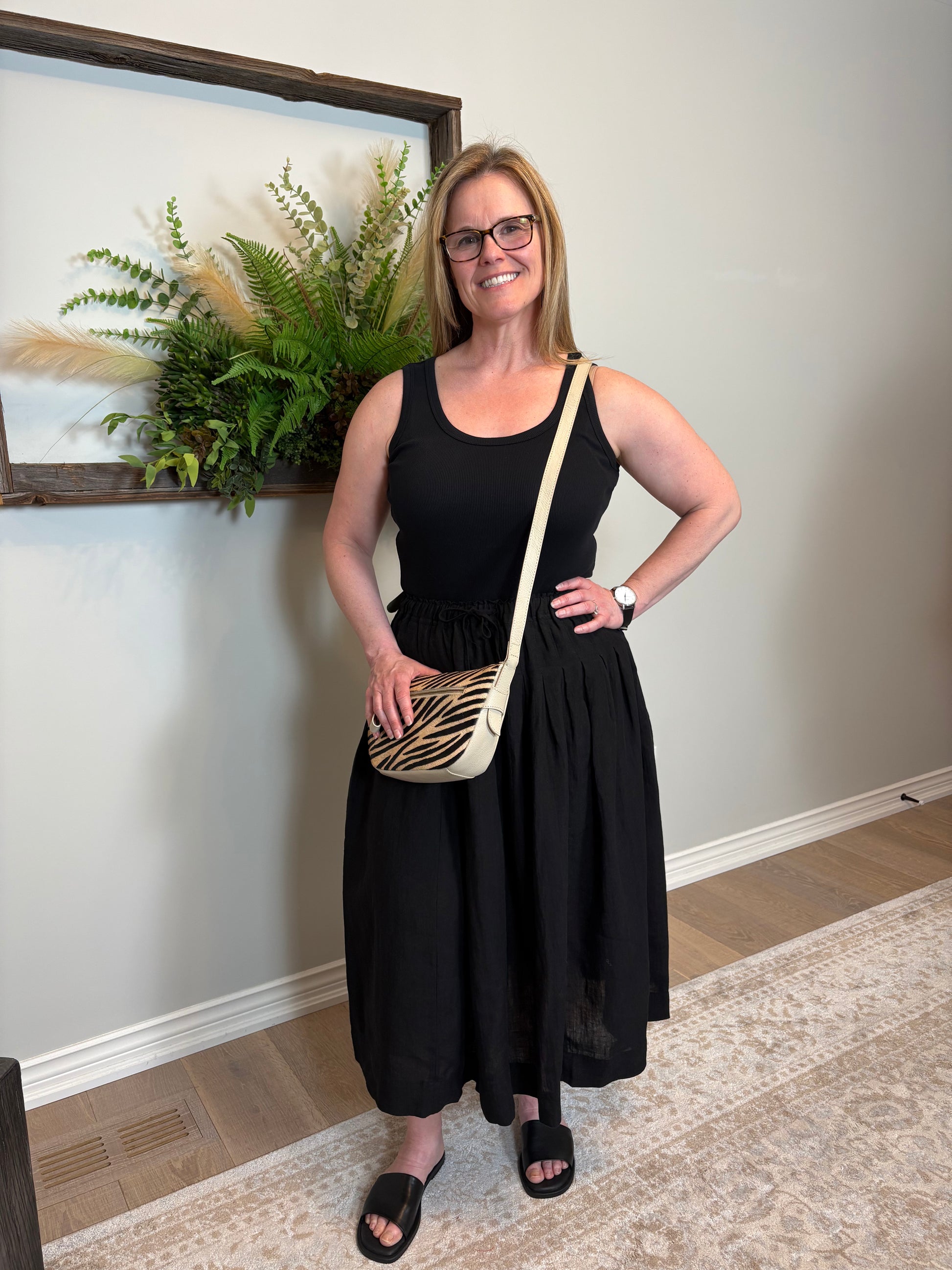 Get ready for some serious twirl action in the Jonie Skirt by Naif. Made from 100% linen, this black full skirt features an elastic waist with a tie front, creating the perfect fit. The beautiful pleating detail adds a touch of elegance to this playful piece.