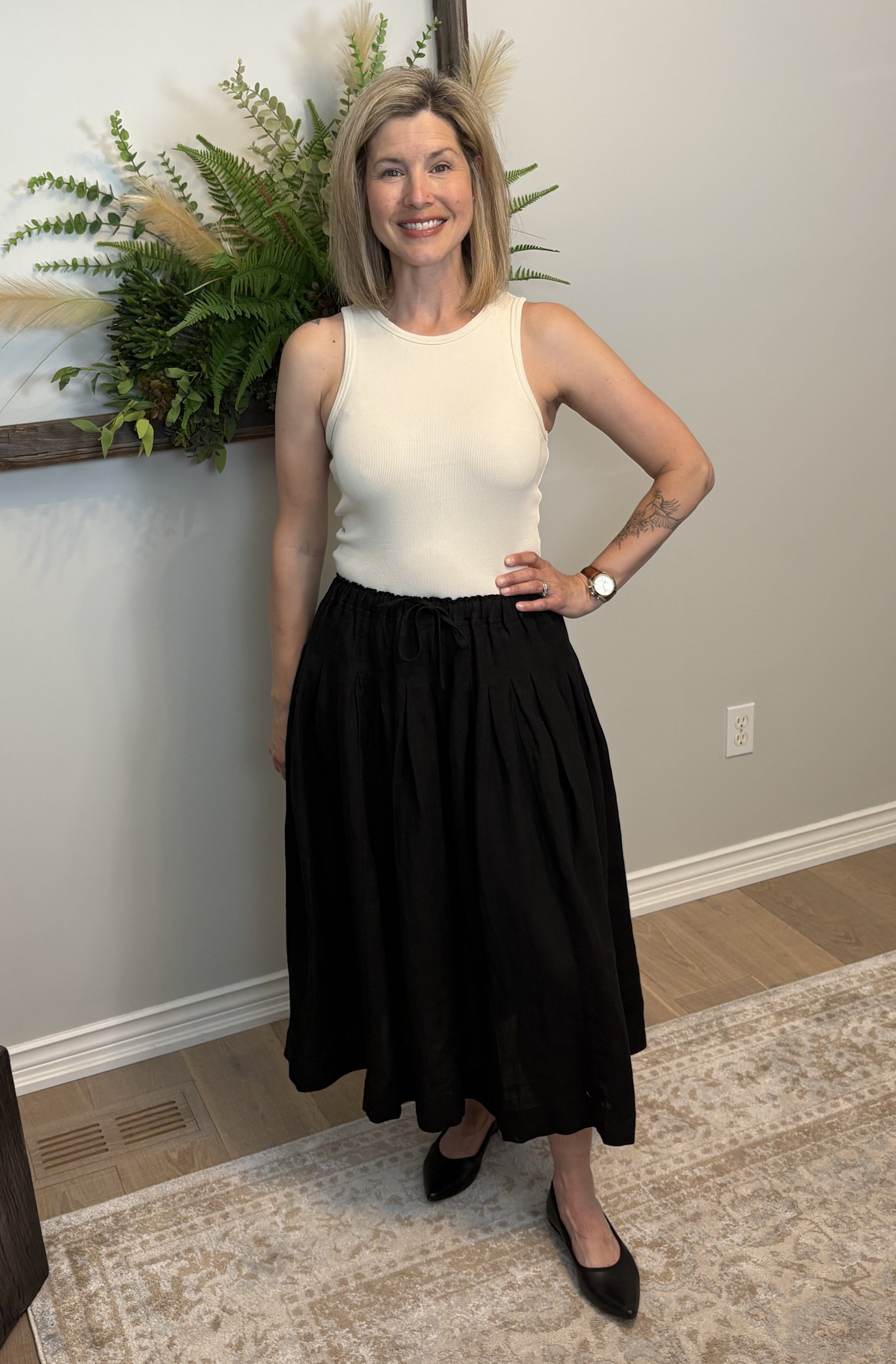 Get ready for some serious twirl action in the Jonie Skirt by Naif. Made from 100% linen, this black full skirt features an elastic waist with a tie front, creating the perfect fit. The beautiful pleating detail adds a touch of elegance to this playful piece.