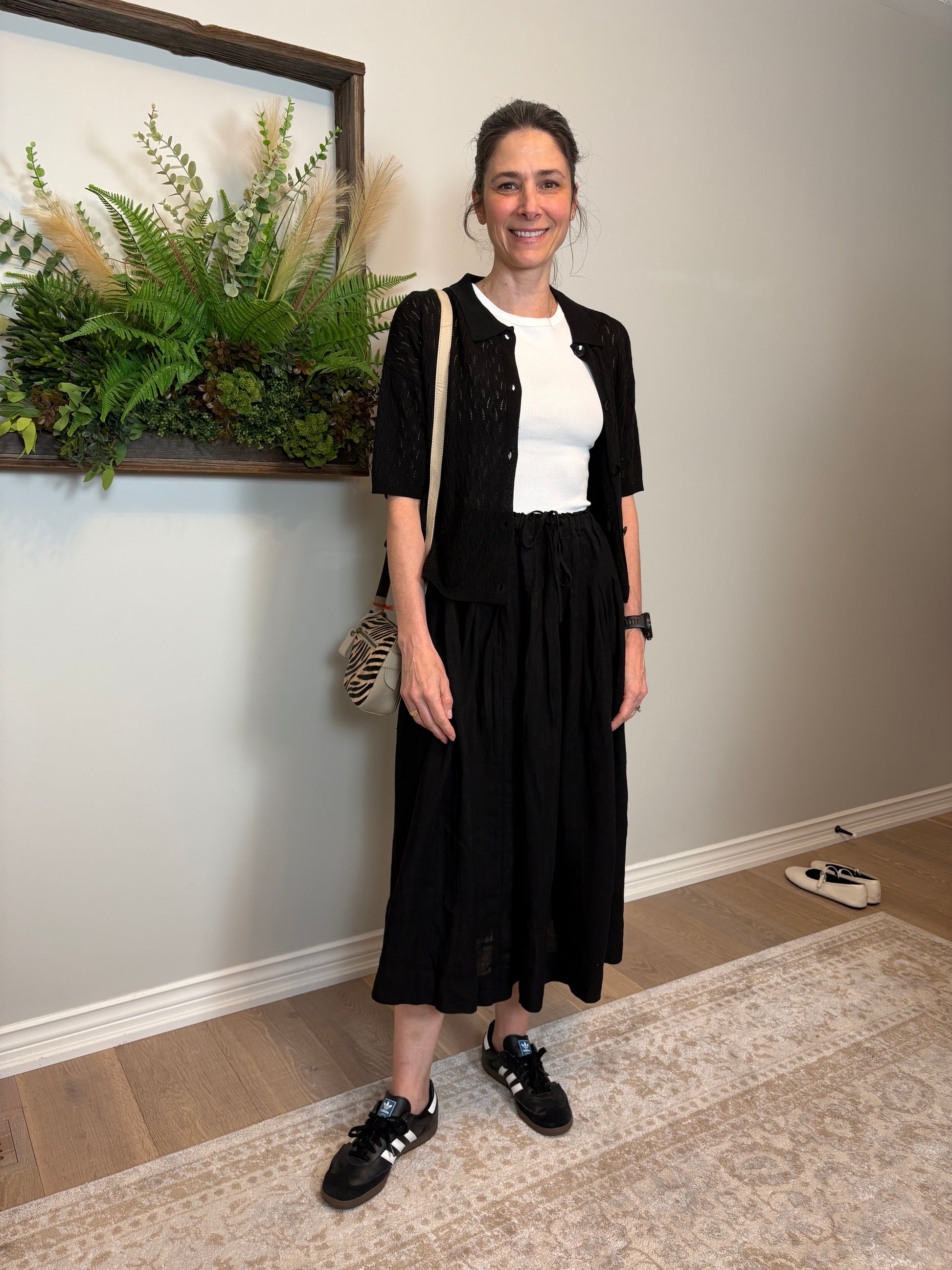 Get ready for some serious twirl action in the Jonie Skirt by Naif. Made from 100% linen, this black full skirt features an elastic waist with a tie front, creating the perfect fit. The beautiful pleating detail adds a touch of elegance to this playful piece.