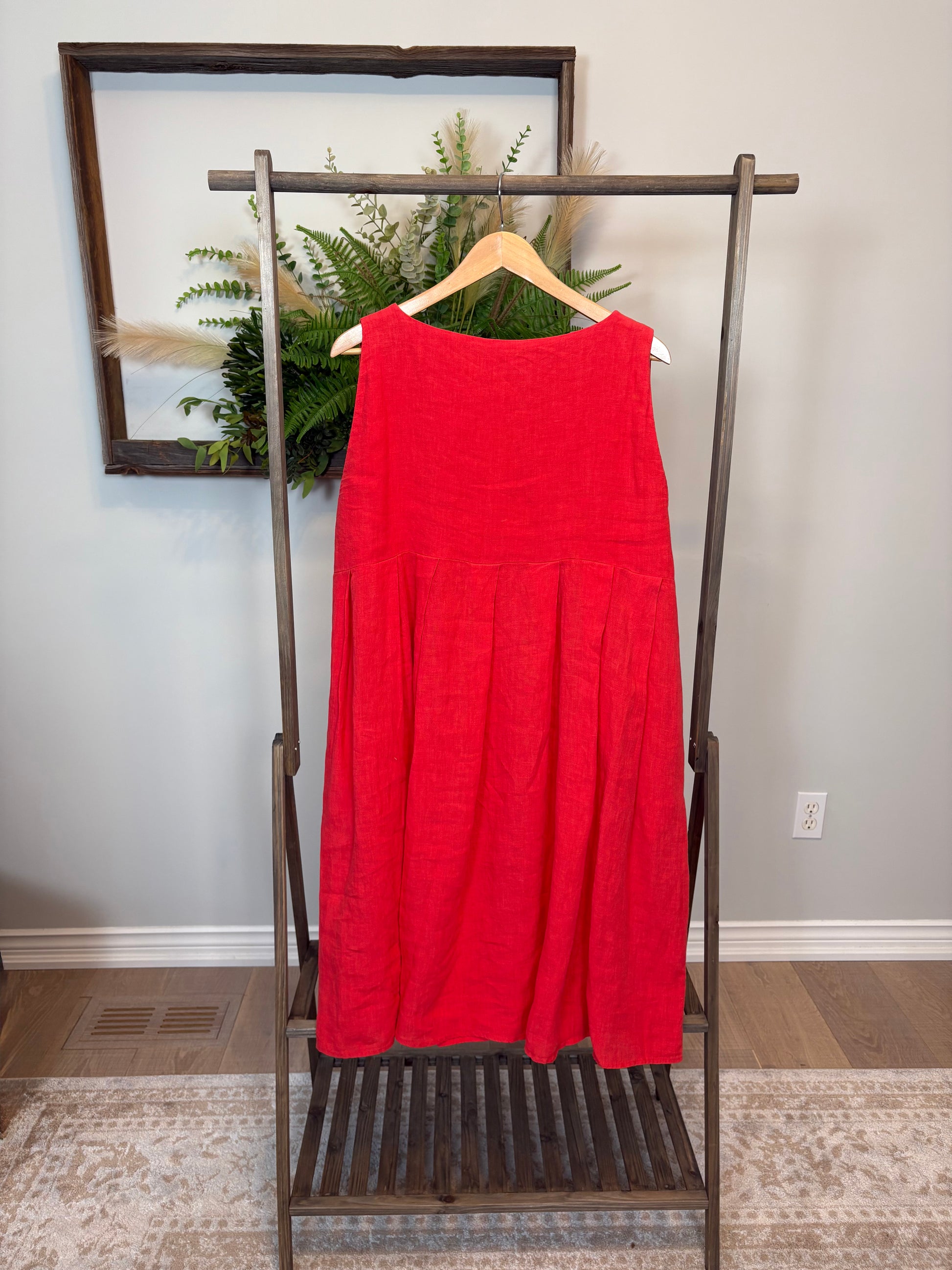 This poppy red Lully Dress by Naif is a standout piece that’s equal parts bold and breezy. Made from 100% linen, it’s lightweight and breathable—perfect for warm days. The sleeveless cut and empire waist give it a relaxed babydoll shape that feels easy and flattering, while the loose A-line fit adds to the laid-back vibe. Buttons down the back add a sweet, unexpected detail