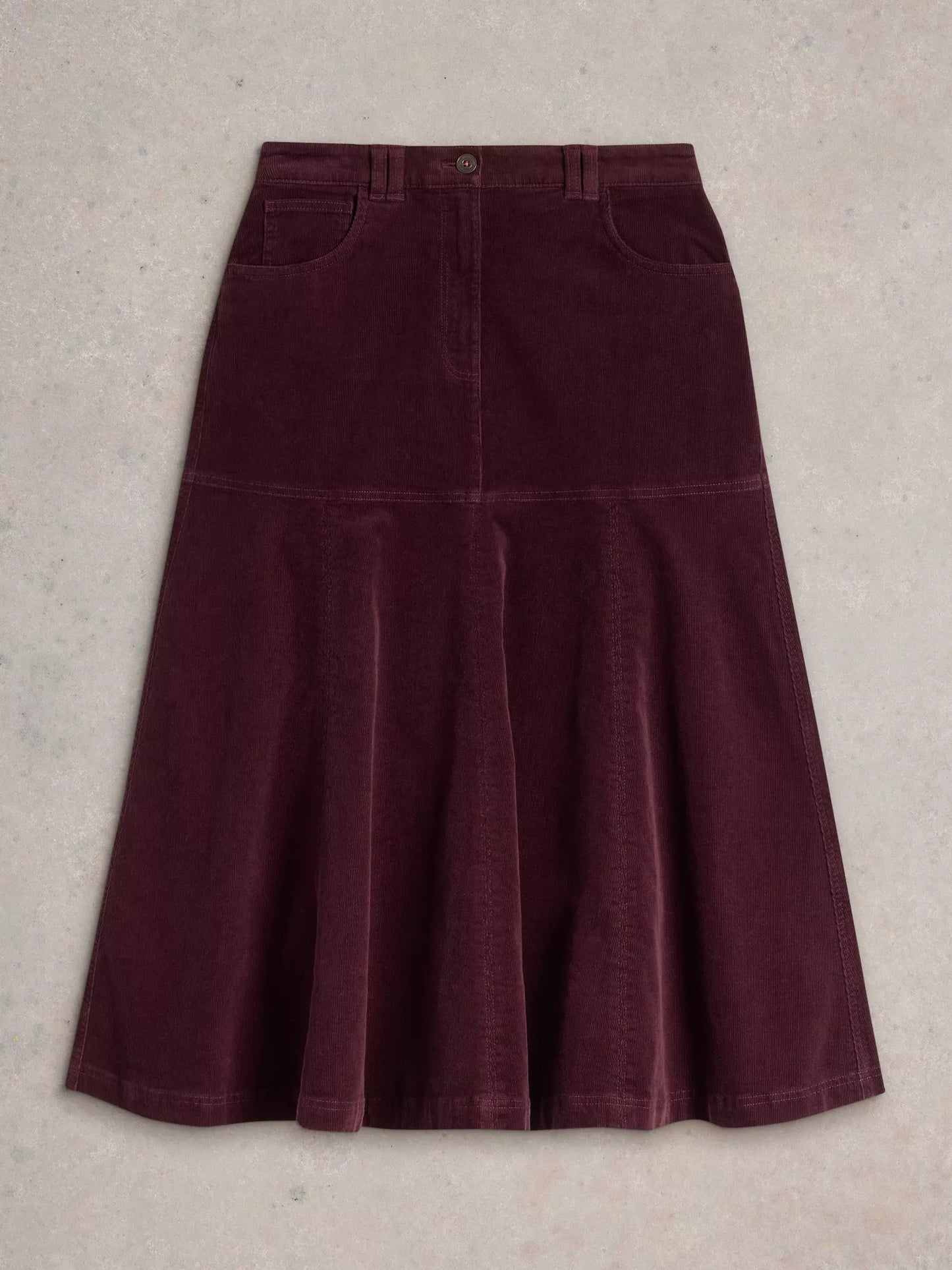 Revamp your wardrobe with The Quinn, a knee-high burgundy cord skirt from White Stuff. Its high waist and midi length make it the perfect addition to any outfit.