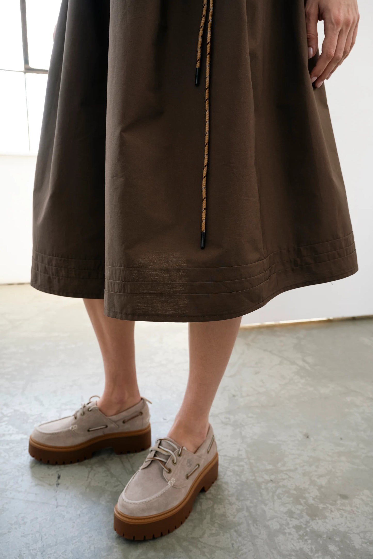 Brown voluminous cotton midi skirt with side cords and pockets by Bodybag by Jude