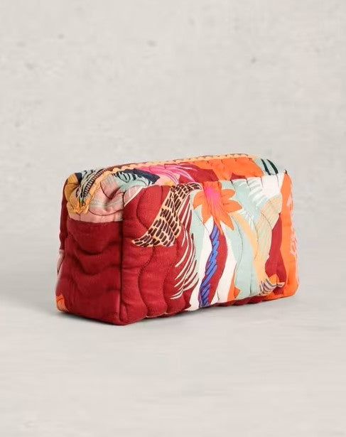 Colorful quilted pouch with floral pattern on a light gray background