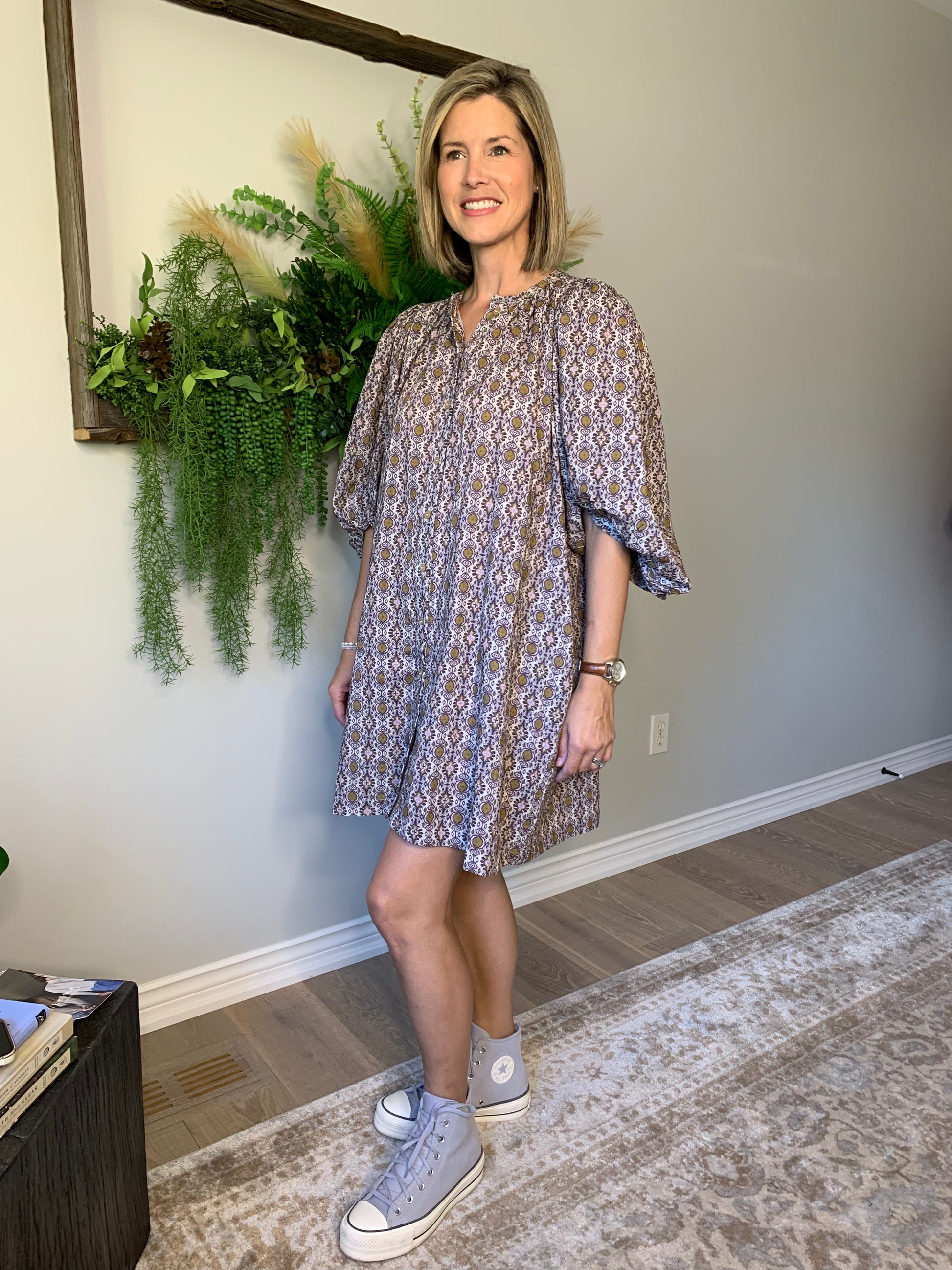 This Buttoned dress by the Korner features a timeless design with a classic round neckline and flattering long puffed sleeves that showcase the flared cut of the skirt, creating a flattering and comfortable silhouette. The geometric pattern in hues of purple with ochre accents is perfect for an autumnal look. lemon cyprus boutique