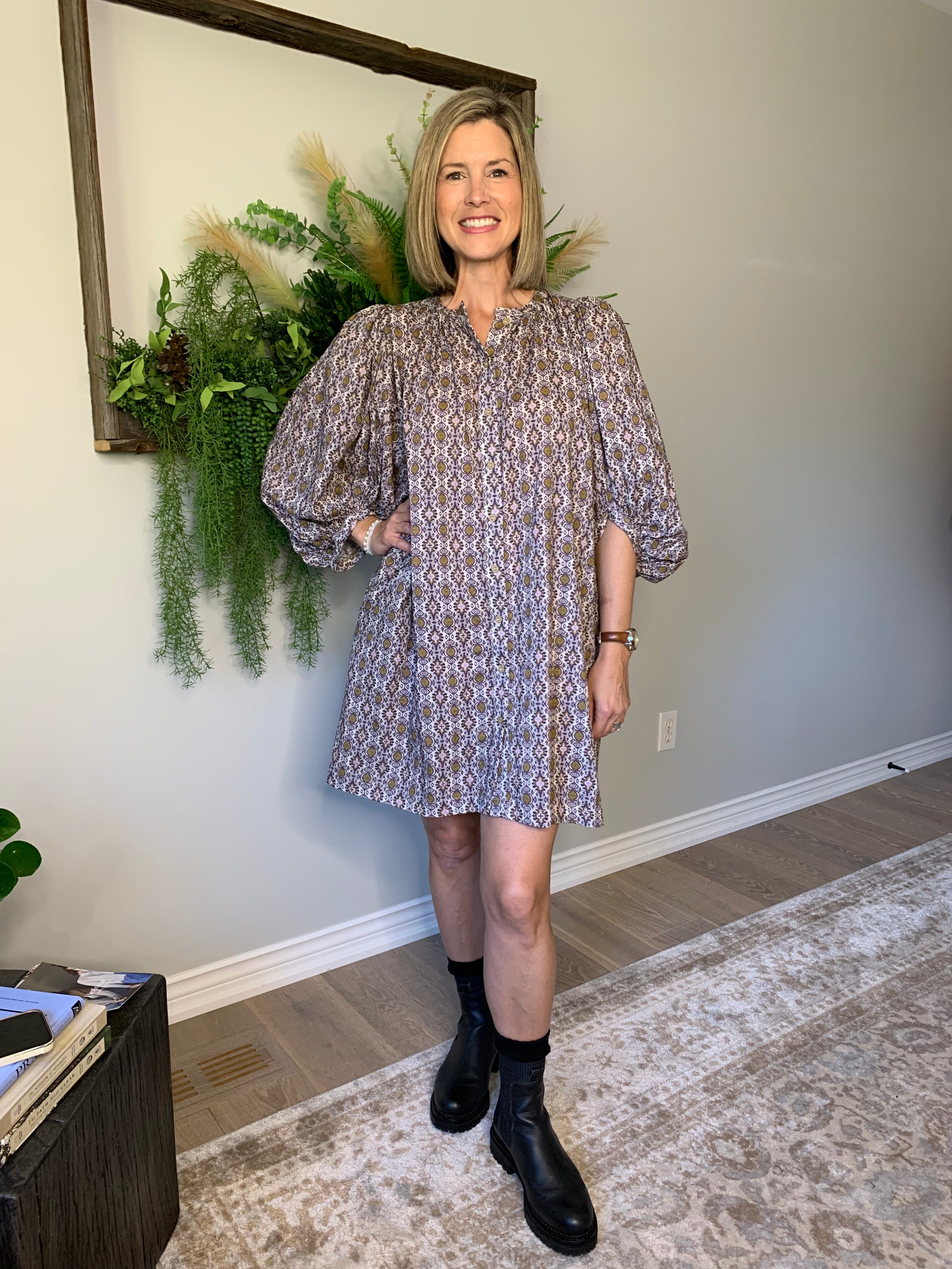 This Buttoned dress by the Korner features a timeless design with a classic round neckline and flattering long puffed sleeves that showcase the flared cut of the skirt, creating a flattering and comfortable silhouette. The geometric pattern in hues of purple with ochre accents is perfect for an autumnal look. lemon cyprus boutique