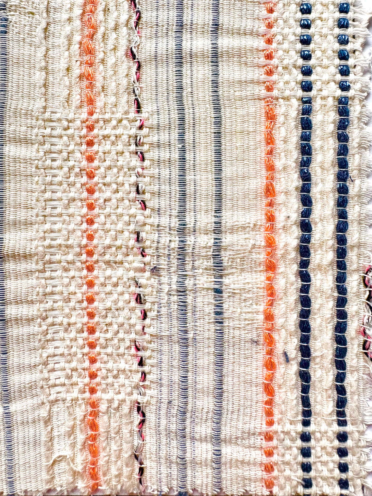 Tulum Top, a tailored fit crop top with a playful sleeveless design and colourful accents. Featuring a crew neck adorned with a beautiful zipper detail, this top is made from a unique fabric that combines blue and orange stripes with metallic blue and pink accents on a cream background. Its loose construction adds texture and allows for breathability, making this top perfect for any fun and chic outfit.