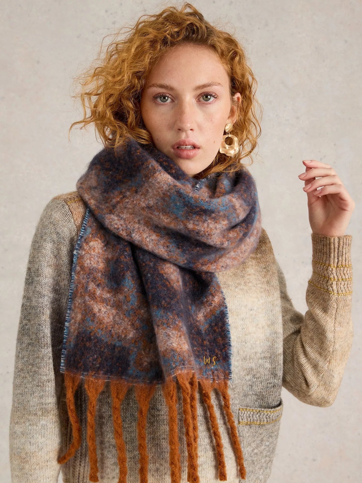  Get ready to snuggle up with the Shelly scarf by White Stuff. This scarf is too cozy to keep hidden - made from recycled materials and featuring a gorgeous, large-scale floral print in blues with a touch of camel colour. The brushed texture adds an artistic touch.