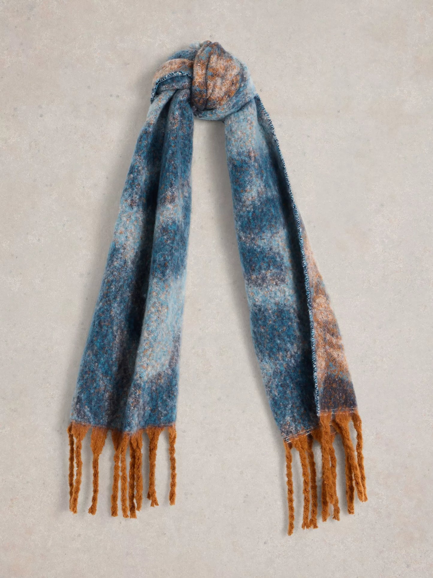  Get ready to snuggle up with the Shelly scarf by White Stuff. This scarf is too cozy to keep hidden - made from recycled materials and featuring a gorgeous, large-scale floral print in blues with a touch of camel colour. The brushed texture adds an artistic touch.