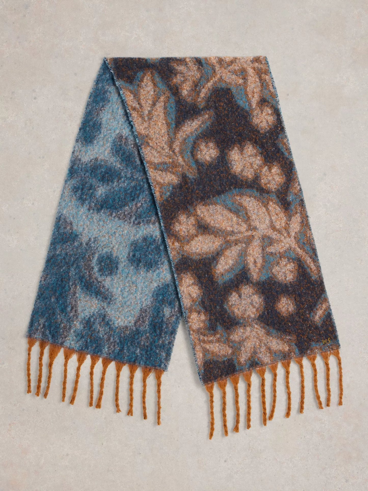  Get ready to snuggle up with the Shelly scarf by White Stuff. This scarf is too cozy to keep hidden - made from recycled materials and featuring a gorgeous, large-scale floral print in blues with a touch of camel colour. The brushed texture adds an artistic touch.