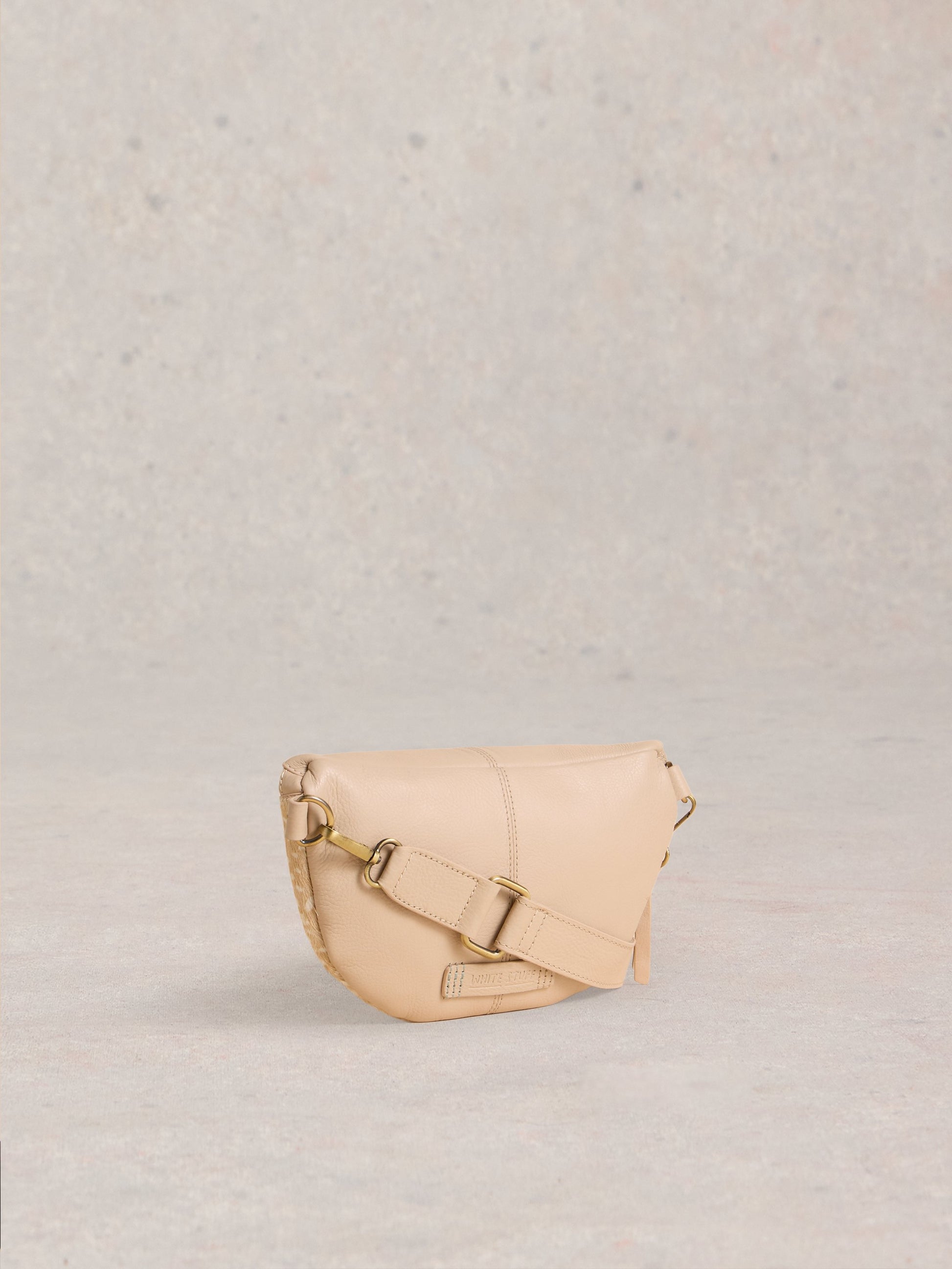 Beige handbag on a light gray background