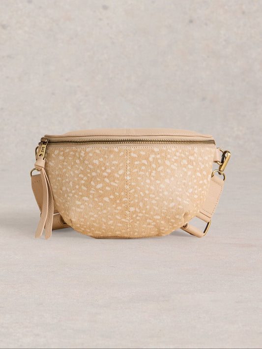 Beige woven bag with a strap on a light gray background