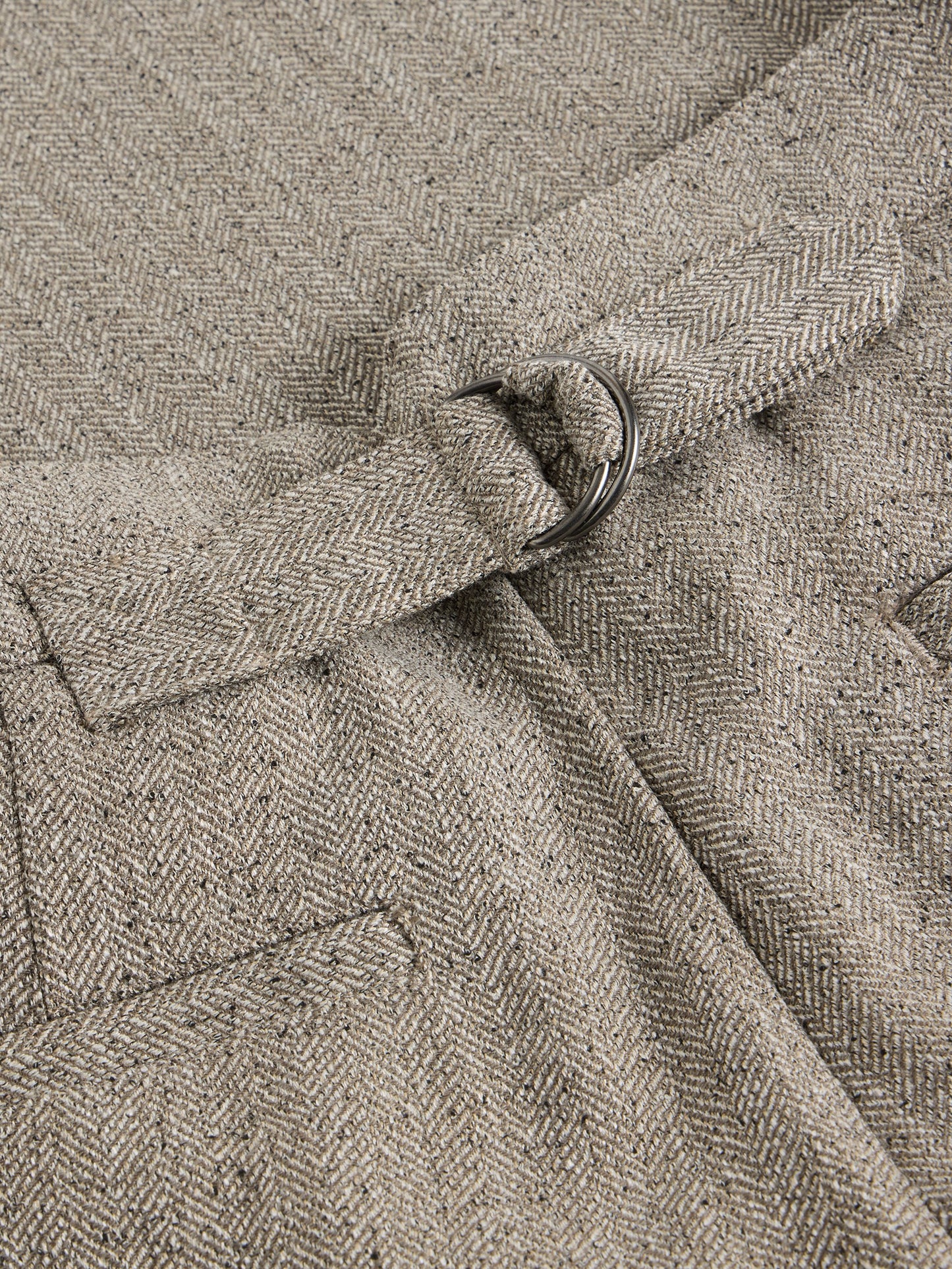 Close-up of a textured fabric with a belt buckle