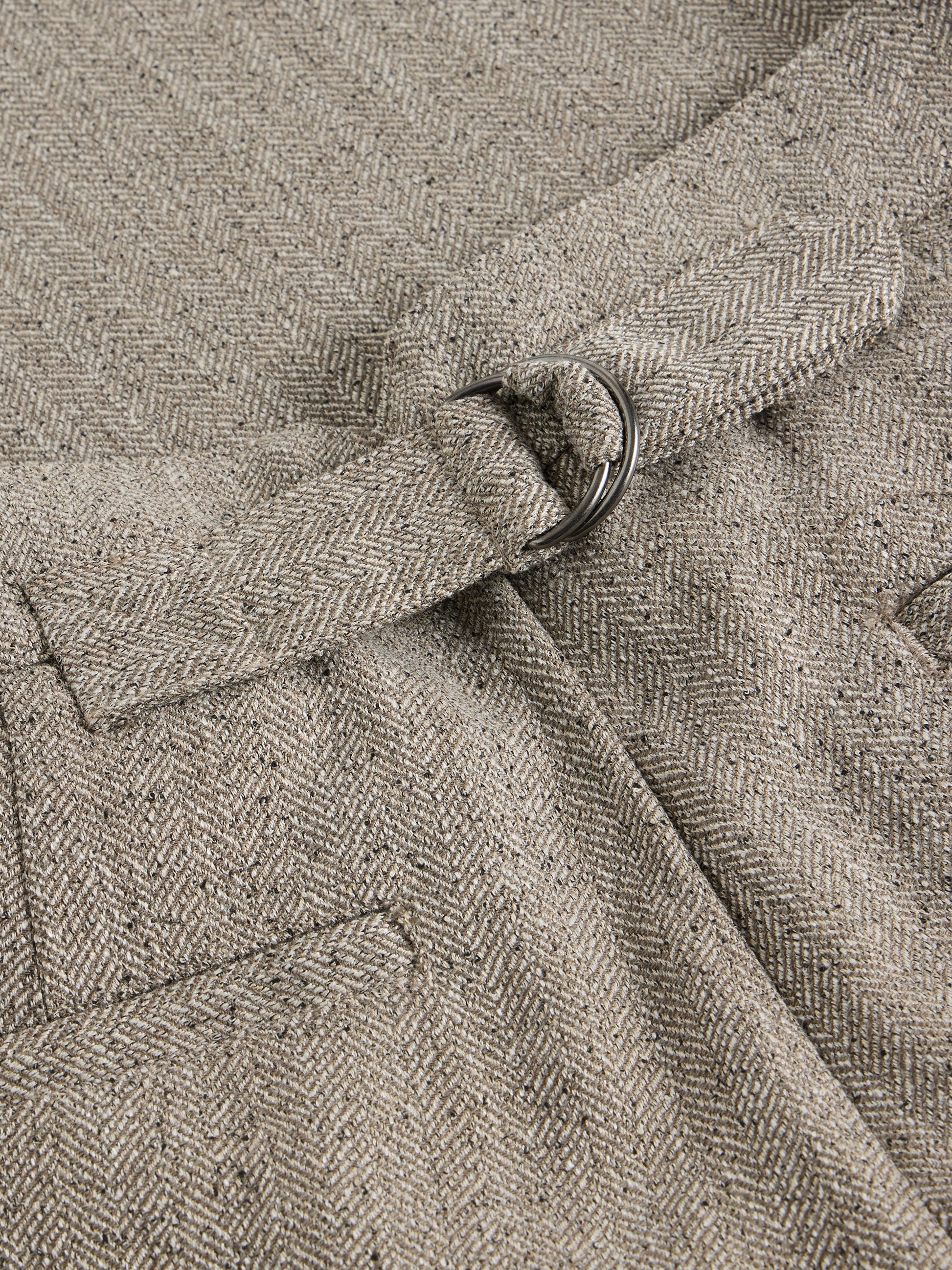 Close-up of a textured fabric with a belt buckle