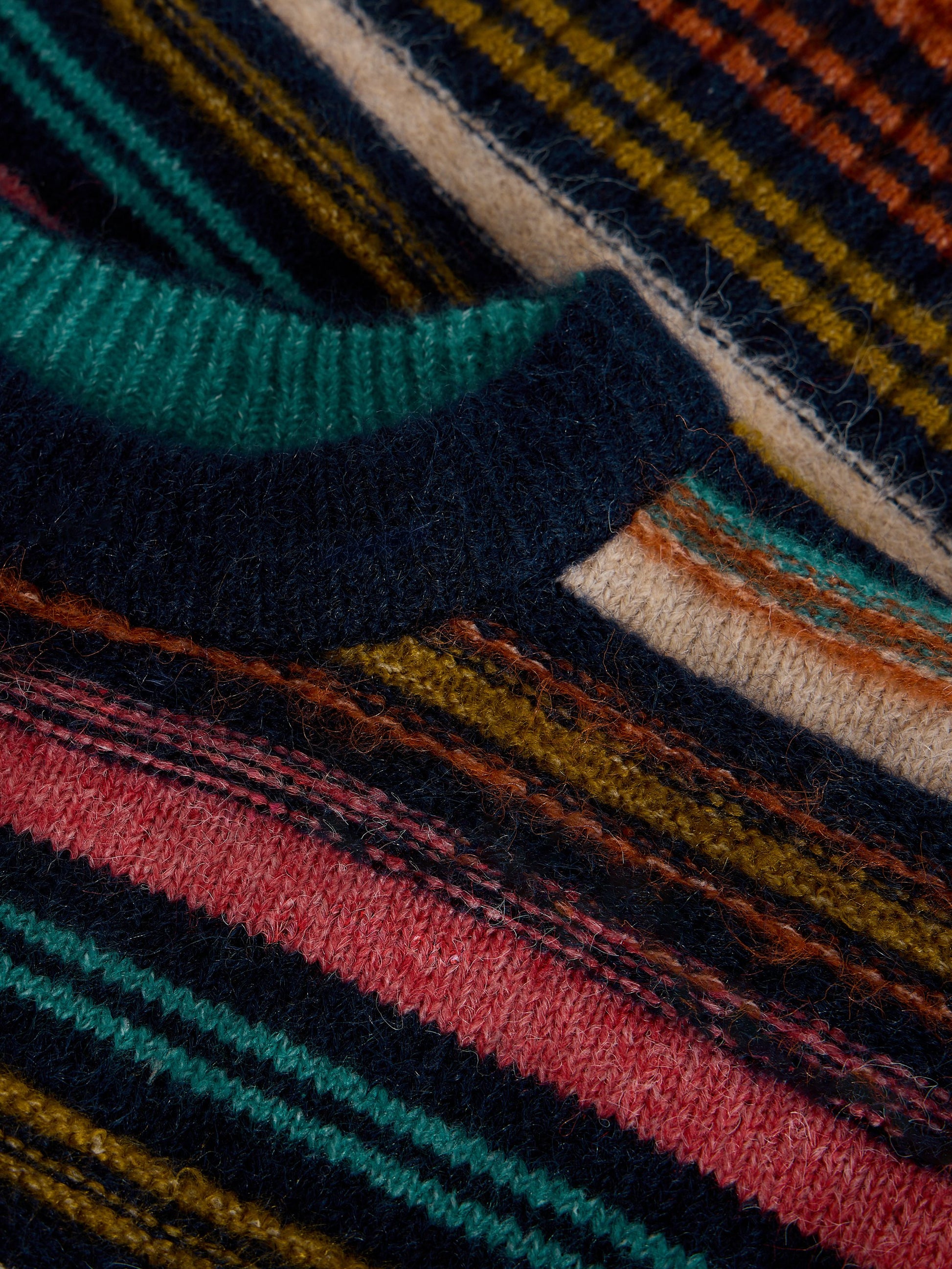 Close-up of multicolored striped fabric with a focus on texture and pattern.
