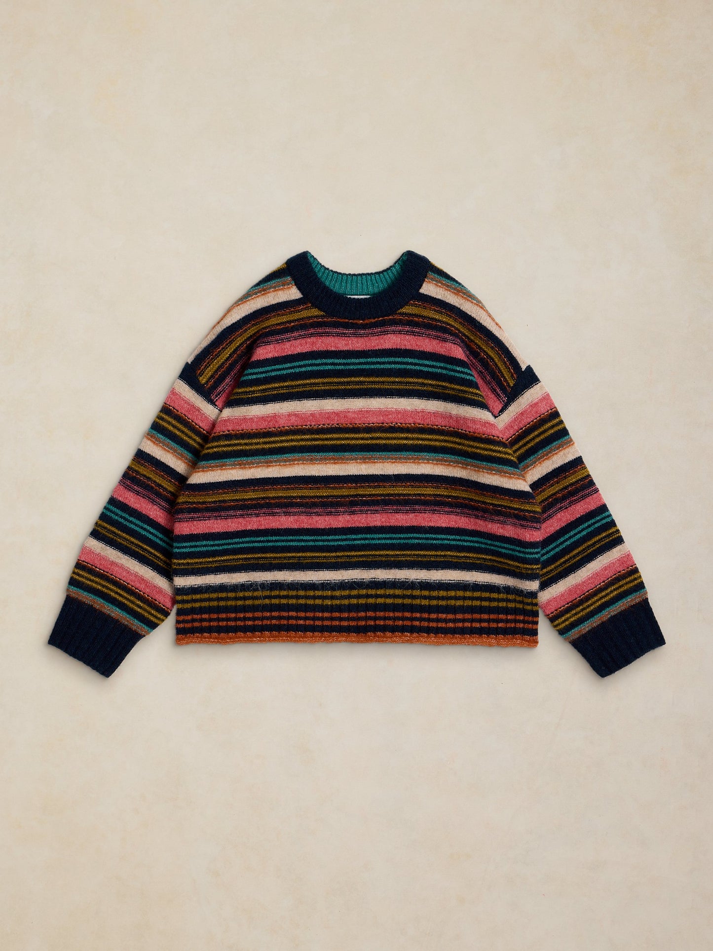 Multicolored striped sweater on a beige background