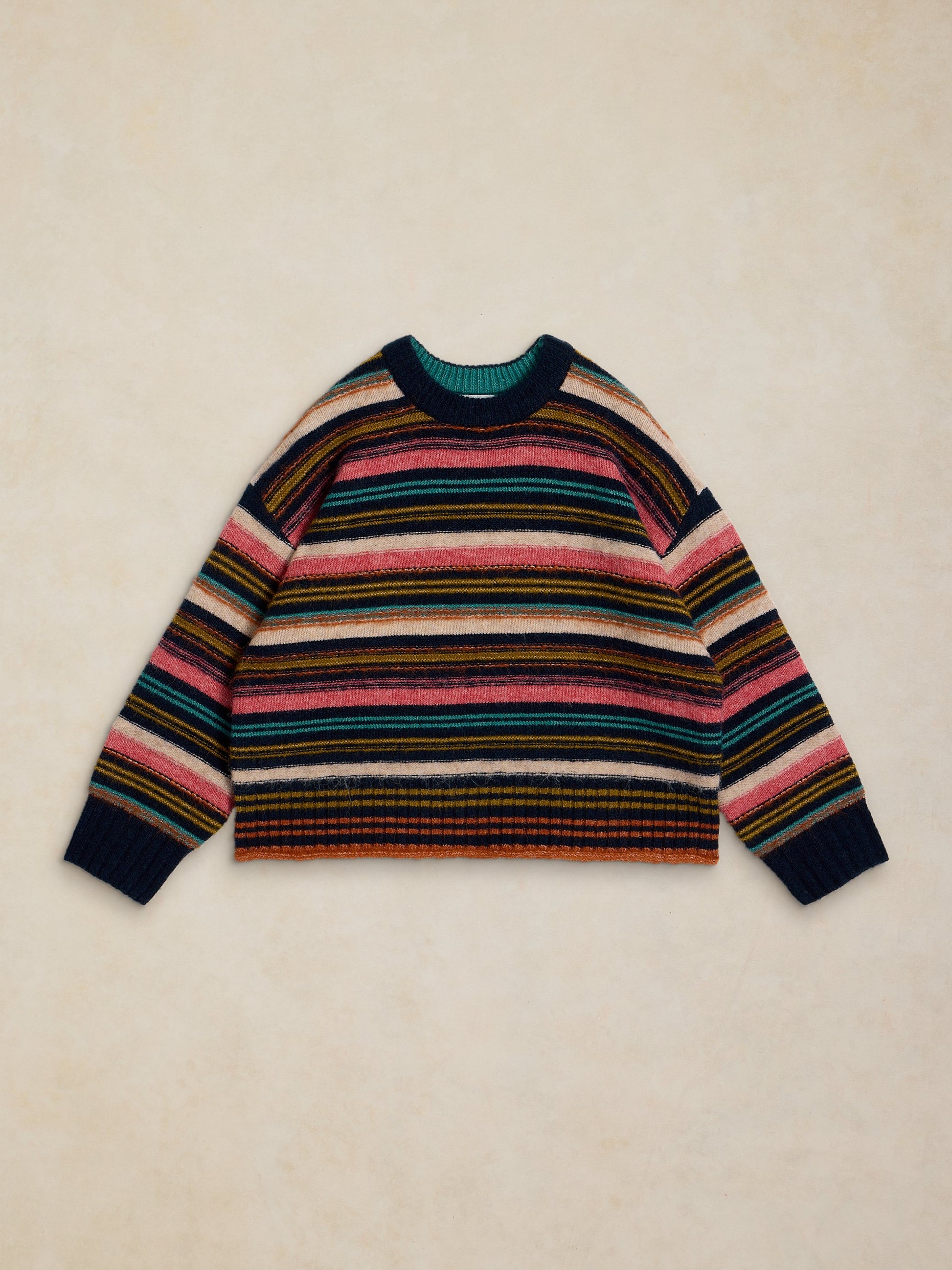 Multicolored striped sweater on a beige background
