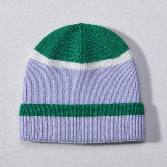 Green and lilac colour block cashmere-blend beanie with white stripe accent, laid flat on a light background.
