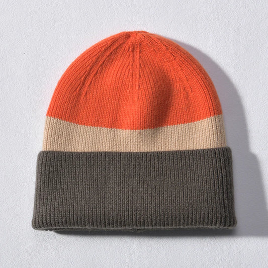 Orange, oatmeal, and olive grey colour block cashmere-blend beanie with deep foldover cuff, laid flat on a light background.