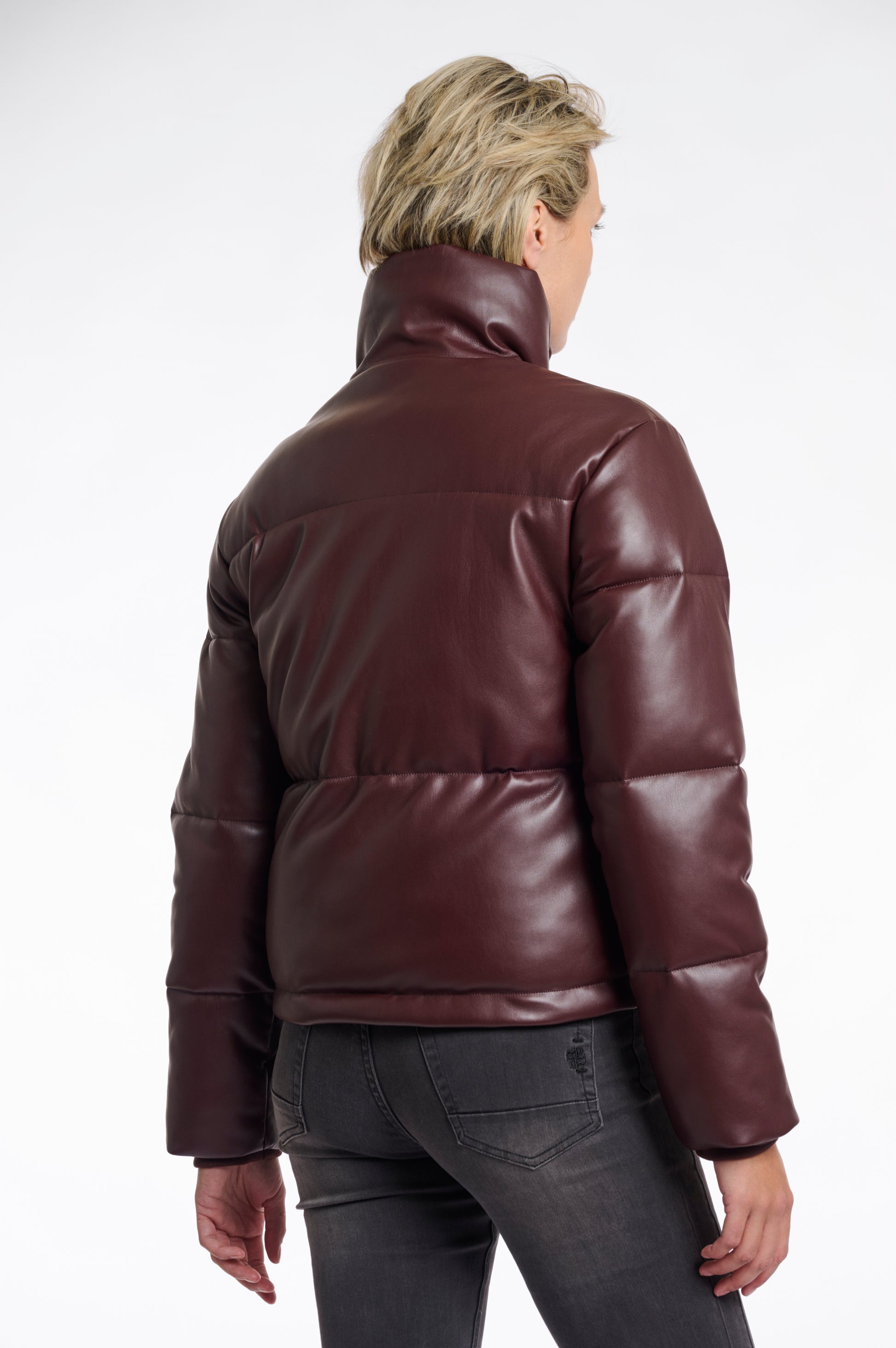 Person wearing a brown leather jacket on a white background