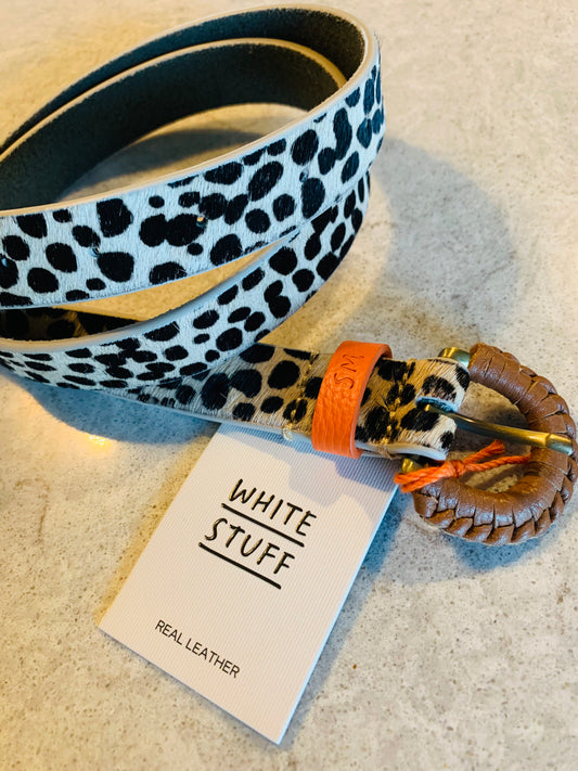 Step into the wild with our statement-making Genuine Leather Leopard Print Belt by White Stuff. Crafted from luxurious calf hair, its bold leopard print is accented with a vibrant pop of orange, adding a playful twist to any outfit. The striking design is further elevated by a stylish cognac-wrapped buckle, marrying sophistication with animal-inspired flair.