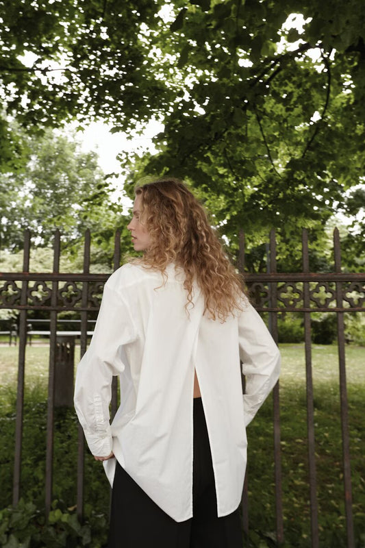 The Jani blouse from Soaked in Luxury is a timeless piece in a soft white. It features long sleeves, a button closure, and a lovely pleat in the back to enhance your silhouette.