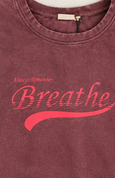 a plum vintage-wash graphic tee with “Always Remember Breathe” script print