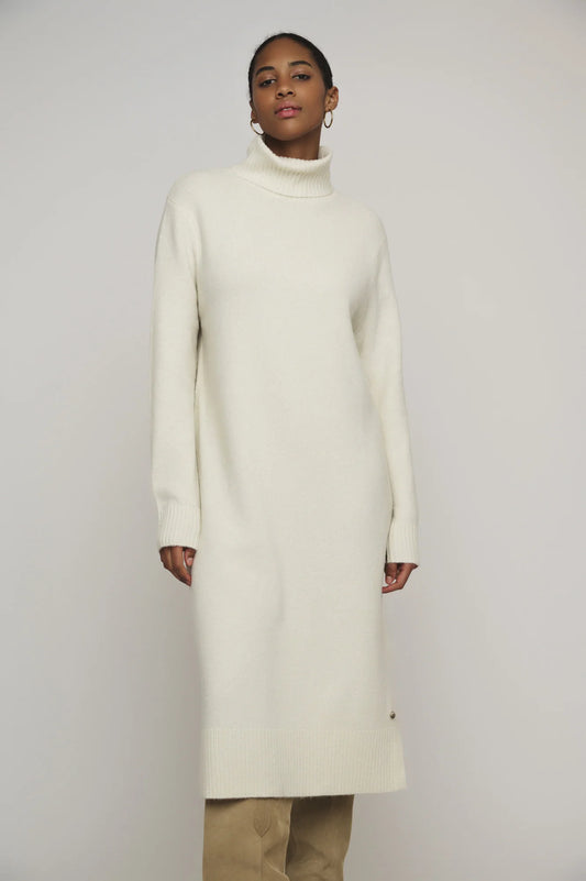 Snuggle up in this knit ivory Tenzil dress from Rino & Pelle for a playful turtleneck, ribbed details, cool side slits, and ultimate comfort. Add some knee high boots and you're ready to hit the town!